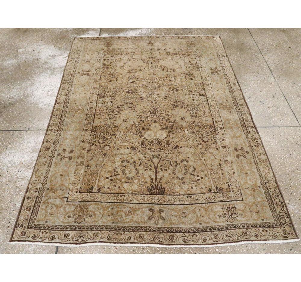 An antique Persian Tabriz accent rug handmade during the early 20th century.

Measures: 4' 5