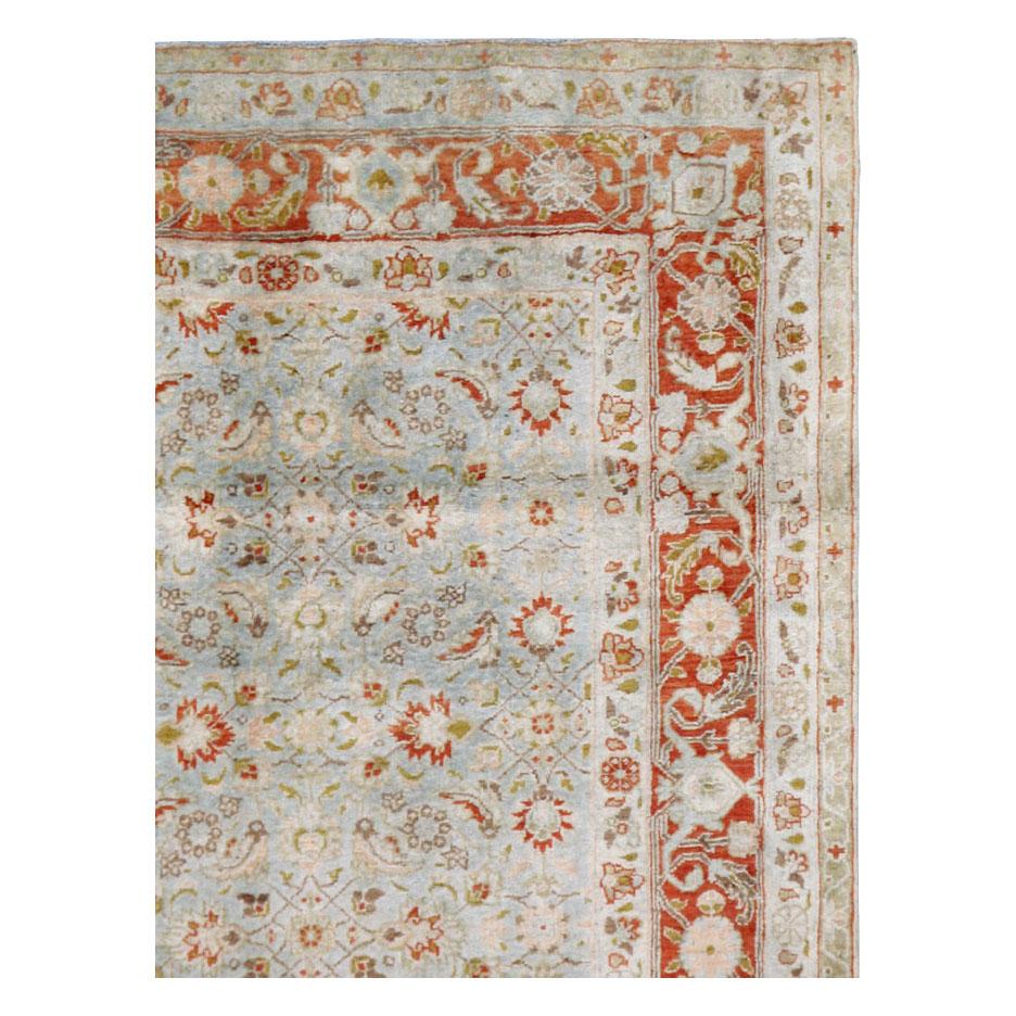 An antique Persian Tabriz accent rug handmade during the early 20th century utilizing the classical Persian 'Herati' all-over pattern with a slate blue field and red border.

Measures: 4' 2
