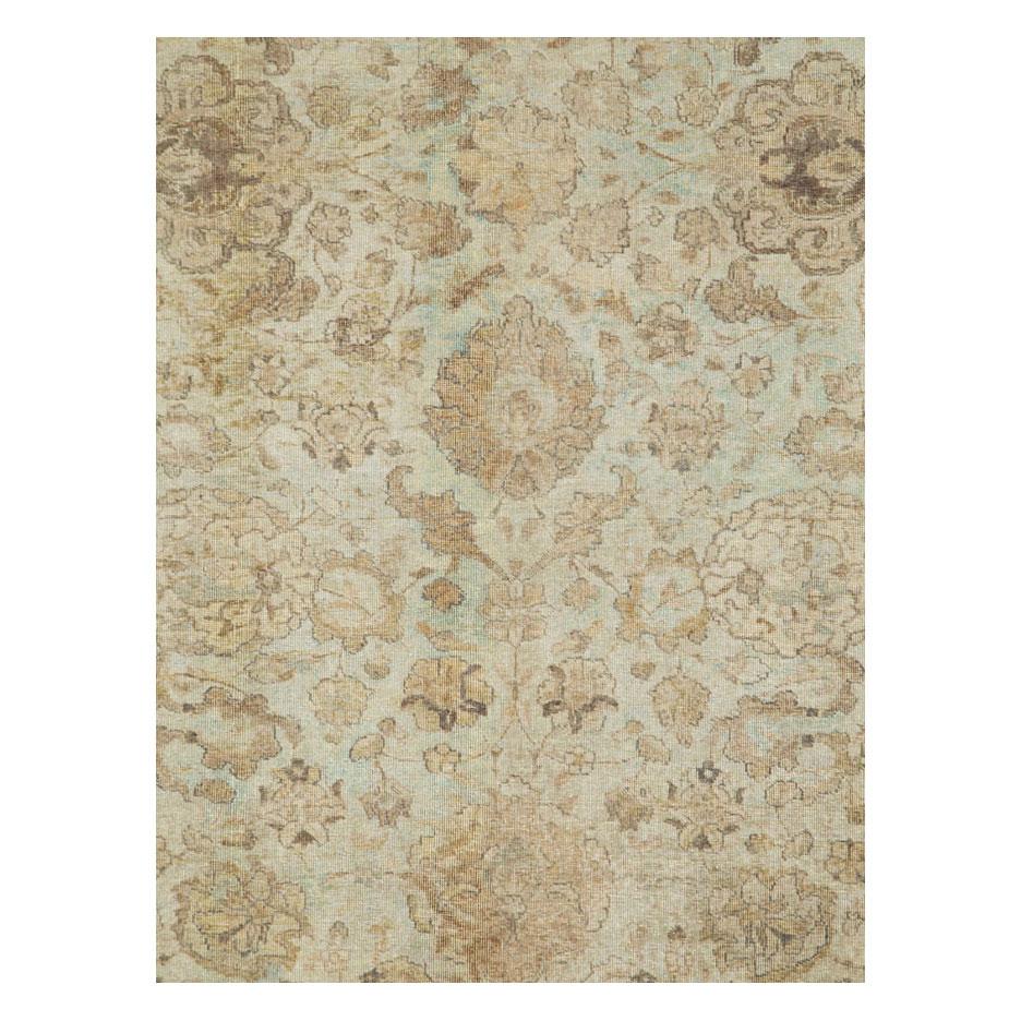 An antique Persian Tabriz accent rug handmade during the early 20th century. The rug consists of muted and neutral tones browns, sienna, creams, and a bluish-green cyan cast.

Measures: 7' 0