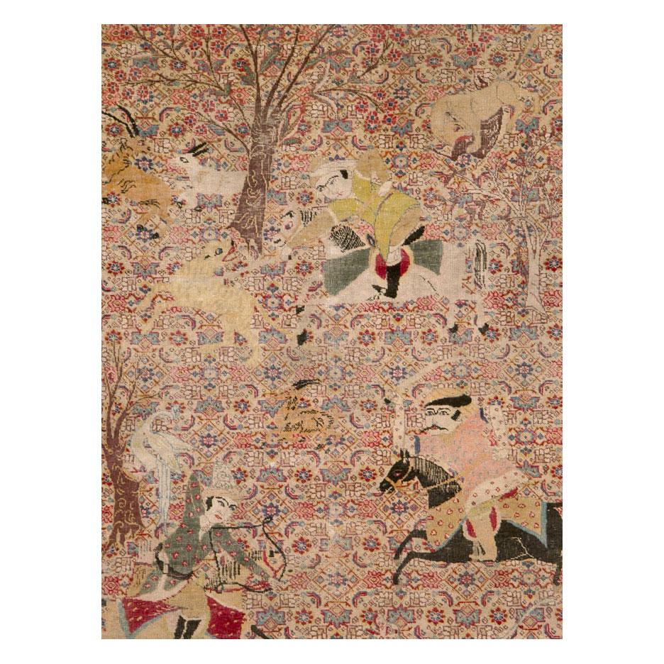 An antique Persian Tabriz accent rug handmade during the early 20th century with the classic pictorial hunting scene design.

Measures: 4' 5