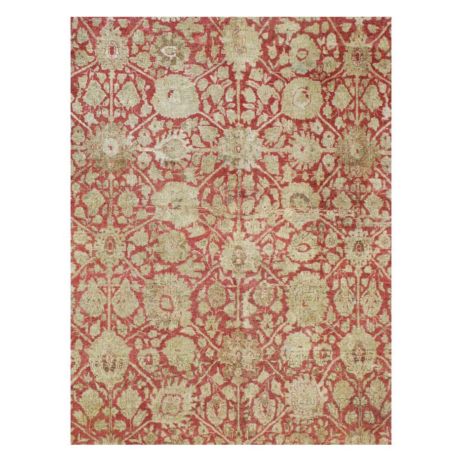 An antique Persian Tabriz large room size carpet handmade during the early 20th century.
