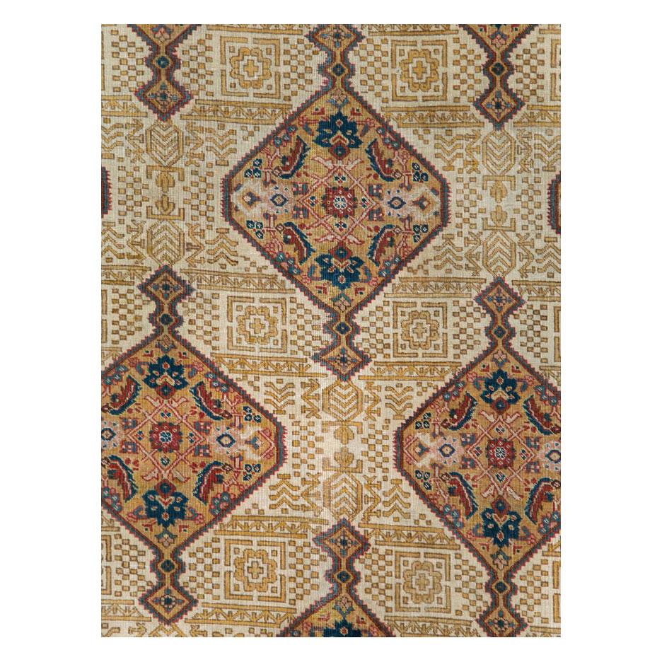 An antique Persian Tabriz room size carpet handmade during the early 20th century.

Measures: 8' 10
