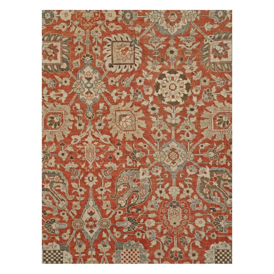 An antique Persian Tabriz small room size carpet handmade during the early 20th century. A vine trellis connects large-scaled palmettes over a rust-red background enclosed by a grey border.

Measures: 8' 0