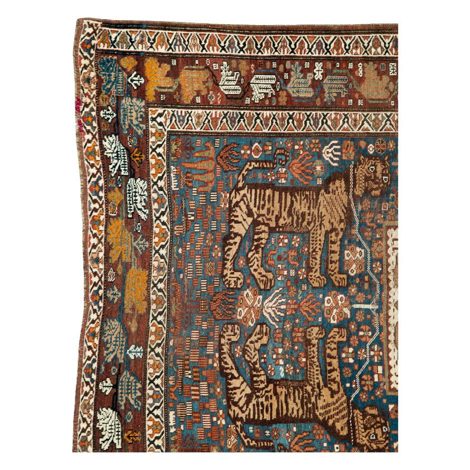 An antique Persian tribal accent rug handmade by the Shiraz tribe of south Persia during the early 20th century with a rare and unusual pictorial design of 4 chained tigers.

Measures: 4' 7
