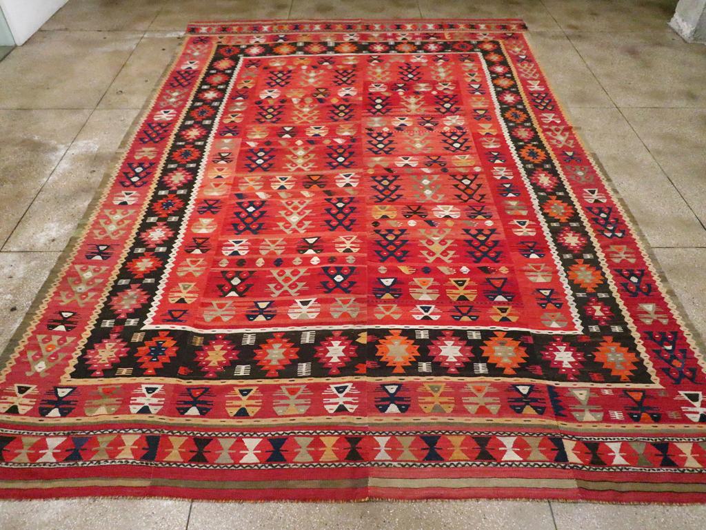 An antique Turkish flatweave Kilim large carpet handmade during the early 20th century.

Measures: 11' 8