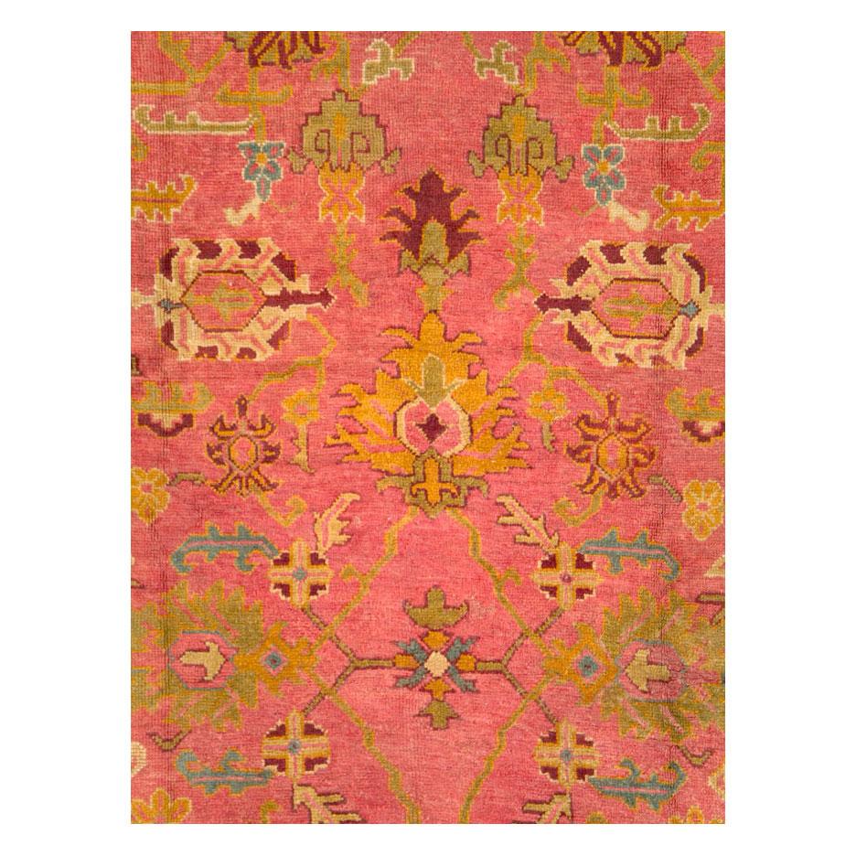 An antique Turkish Oushak room size carpet handmade during the early 20th century with an acid green border and pink field.

Measures: 10' 9