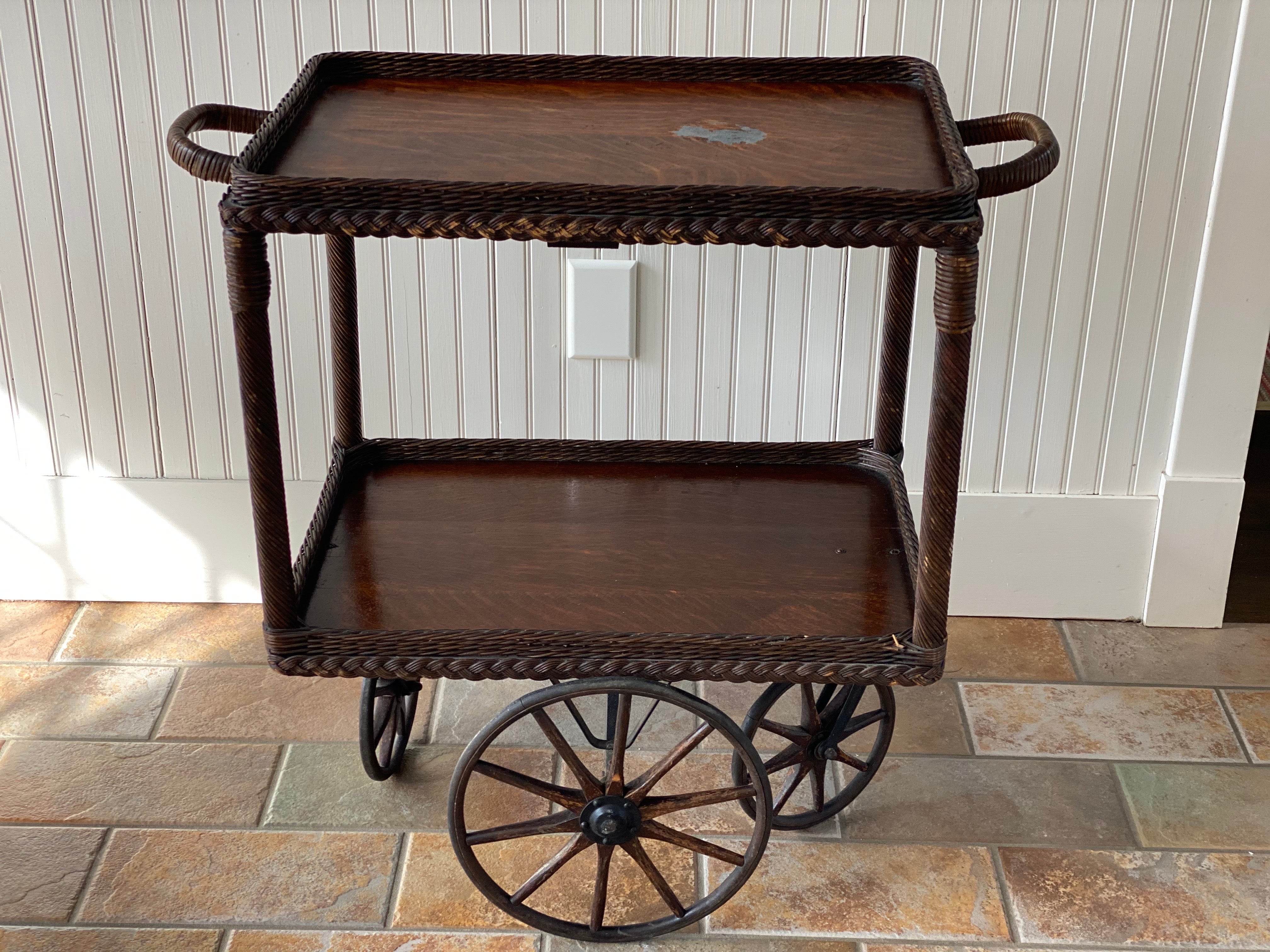 Haywood Wakefield Vintage Wicker Tea/Bar Cart
This tea cart is crafted by Haywood-Wakefield. Known for their innovative use of materials and design, Haywood Wakefield has been a staple in American furniture since the early 20th century. This piece,