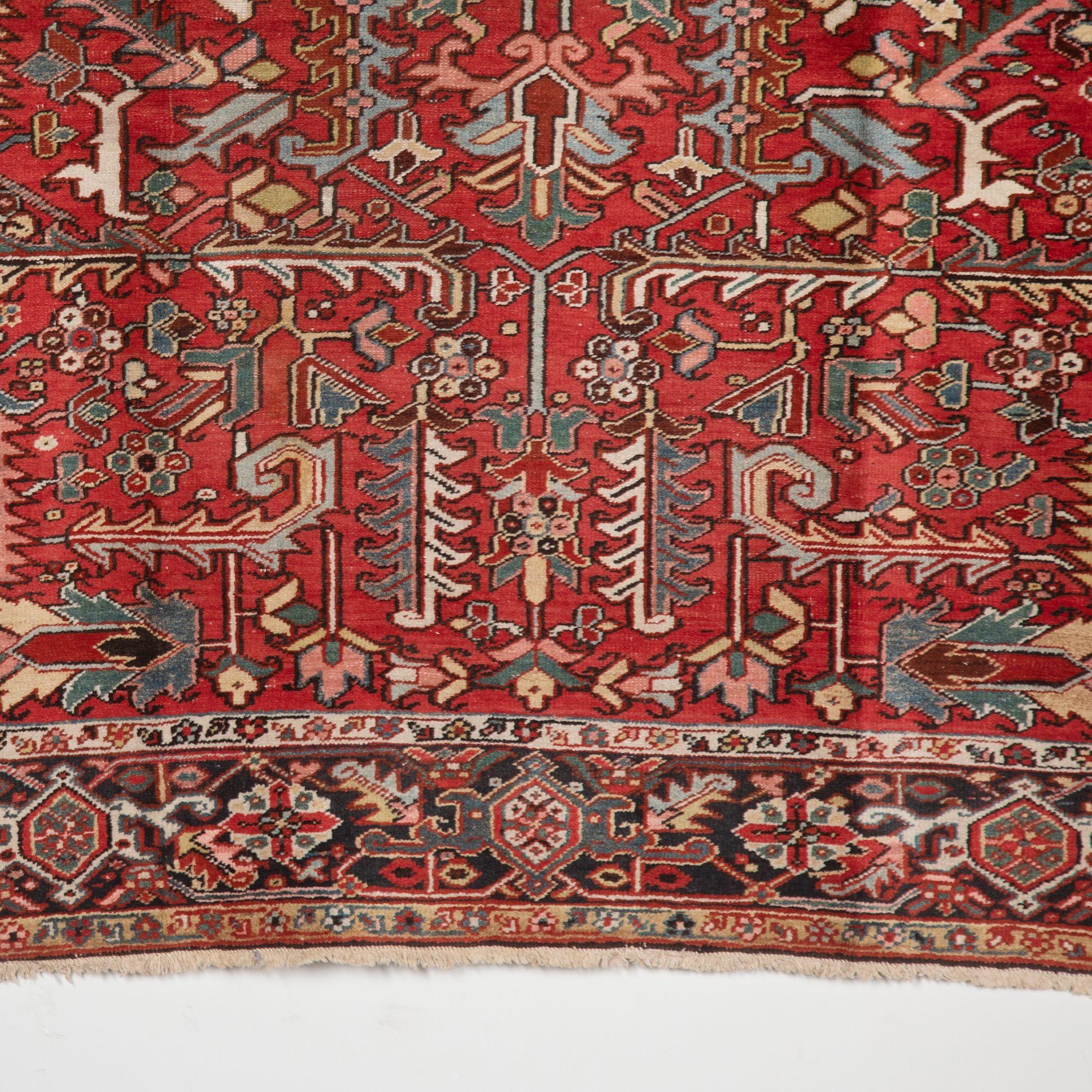 This charming early 20th Heriz carpet has a creative overall drawing rather than a traditional central medallion motif inspired by rare 19th-century Kuba rugs from the Caucasus.
The attractive terracotta red field harmonises the naturally dyed