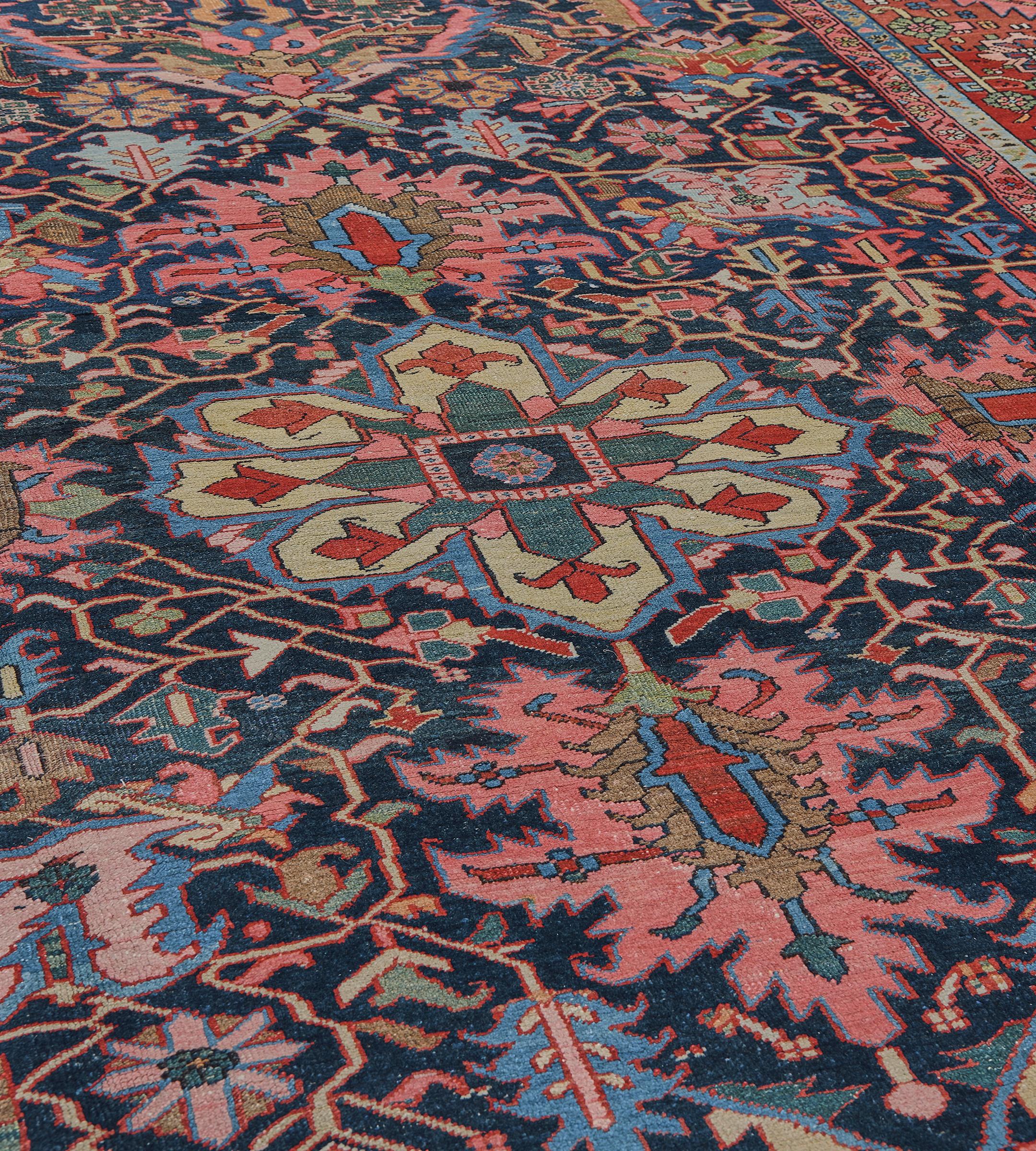 This traditional hand-woven Persian Heriz rug has a deep indigo overall field of angled polychrome vines issued by broad palmette icons, in a magnificent shaded brick scrolling geometric rosette border, between delicate stripes.

About Antique Heriz
