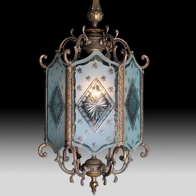 Early 20th century French ornate brass-framed and etched glass hexagonal lantern, the six shaped, etched and cut-glass panels held within an ornately scrolled brass frame.

 