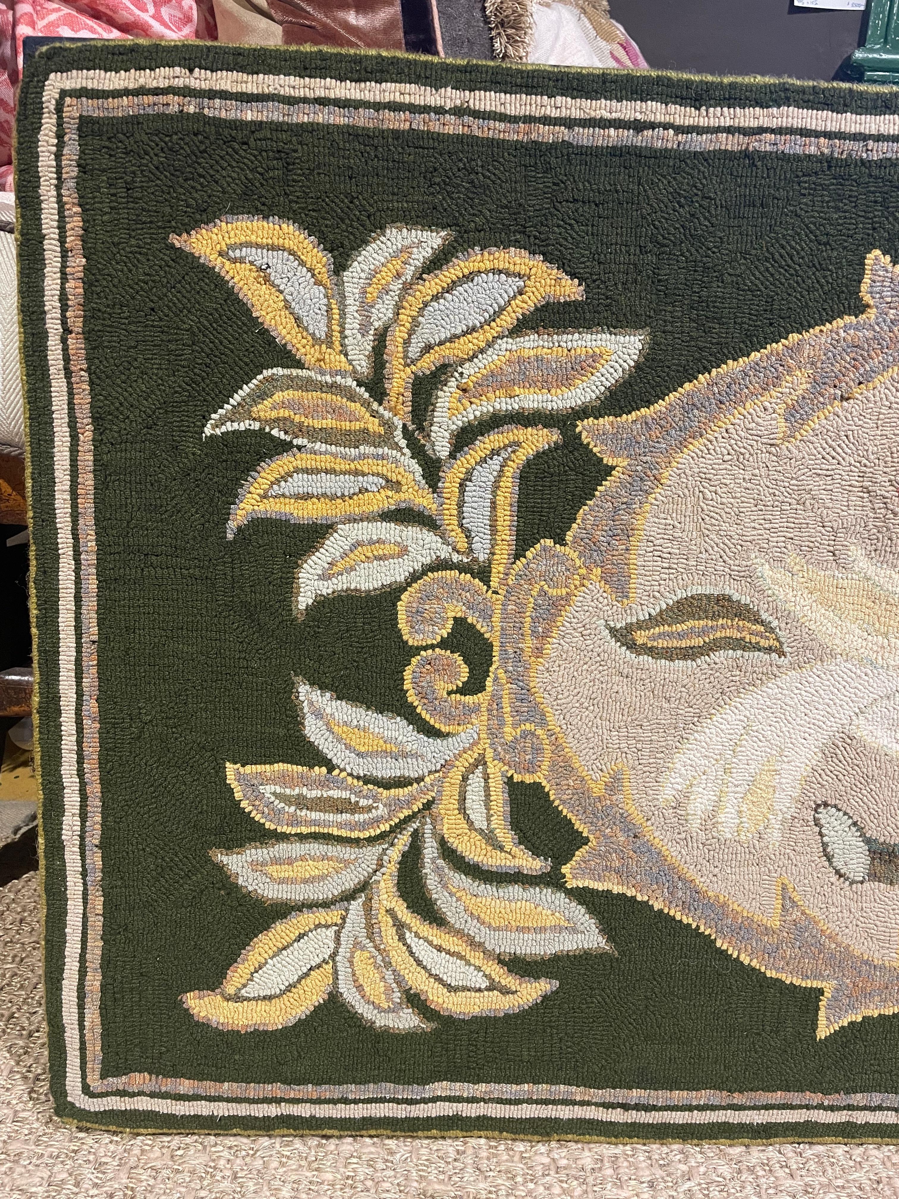 Turn of the century/early 20th century hooked rug, mounted for wall hanging on black linen and foam core stretcher. With evergreen ground and white and variegated striped border. Central medallion flanked with vegetal designs in