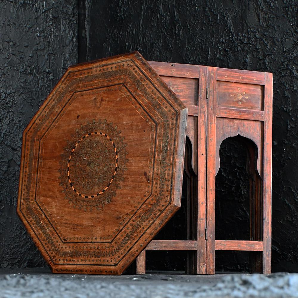 Early -20th Century Hoshiarpur table  
A highly decorative early-20th Century brass inlay Hoshiarpur occasional side table. Covered in intricate hand worked geometric floral patterning. This item easily folds into two sections as shown for ease of
