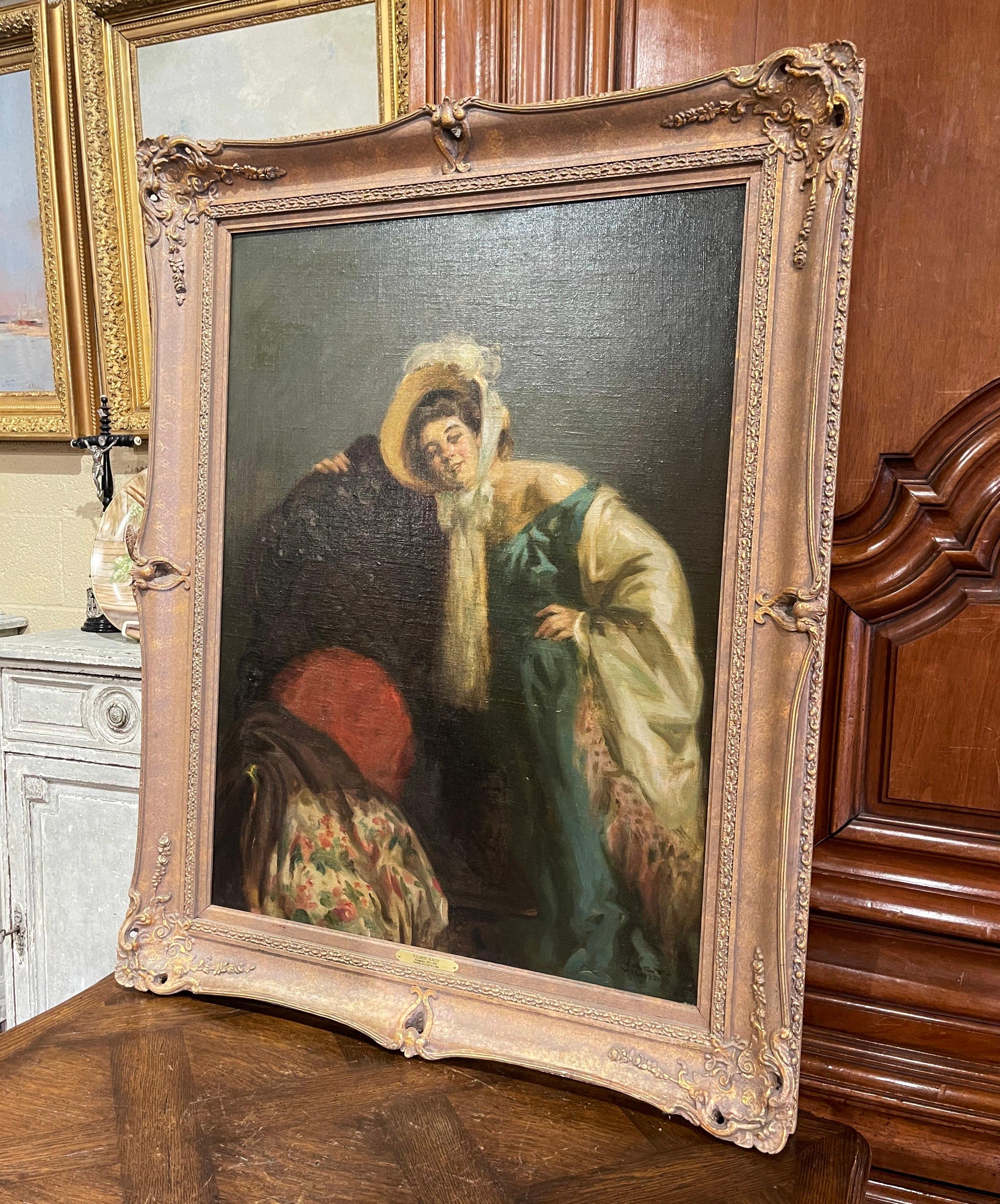 Décorez le bureau ou l'étude d'une dame avec cette élégante huile ancienne sur toile. Créée en Hongrie vers 1920 et placée dans un cadre en bois doré sculpté, l'œuvre d'art, intitulée 