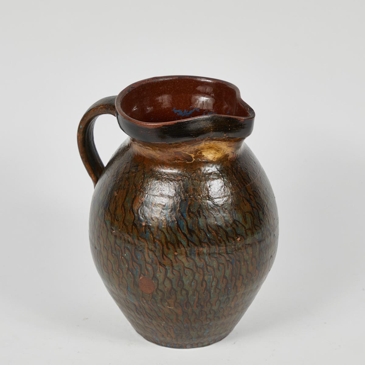 Early 20th century Hurlington Ware pitcher with teal and bronze painted detail.