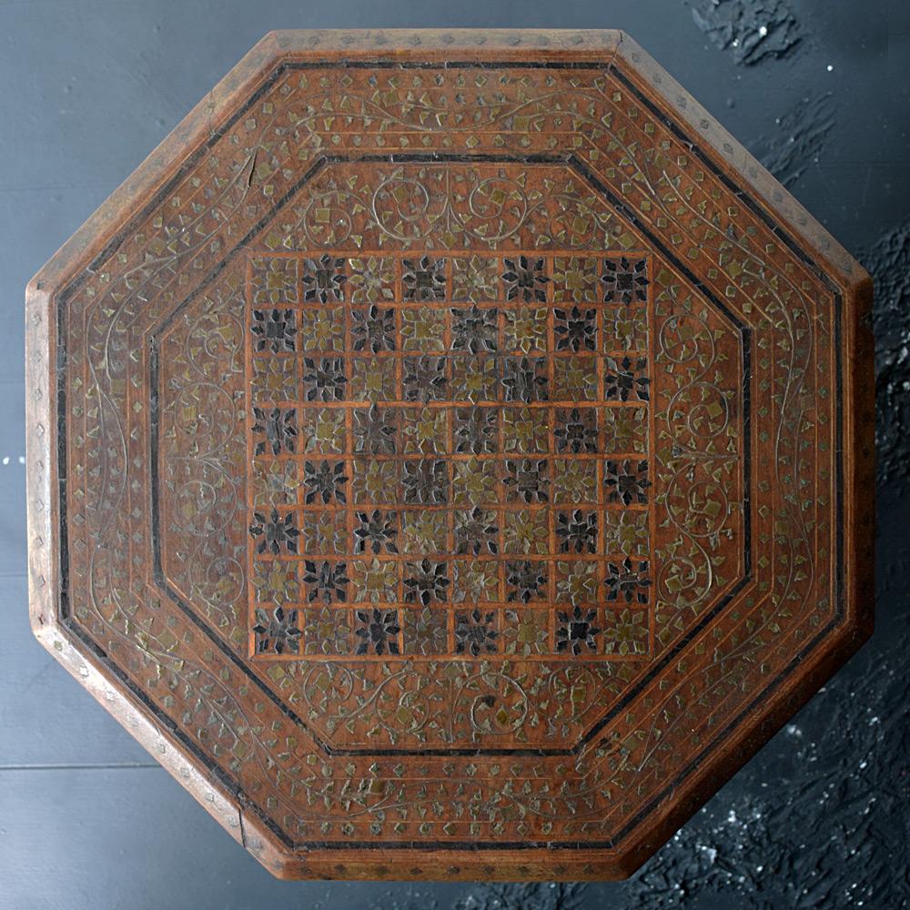 Early- 20th century Indian brass inlaid table 

Made from hard wood and covered with decorative checkers motif design brass and wooden inlaid detail. This example dates from the first quarter of the 20th century, showing lots of natural age and a