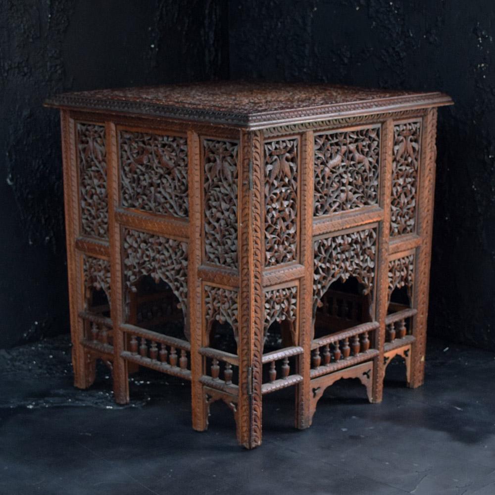 Early 20th century Indian square hand carved occasional table. 

A highly decorative example of an early 20th century square hand carved Indian occasional table. Covered in ornate hand carved detail with animals and foliage. 

Size of inches: H