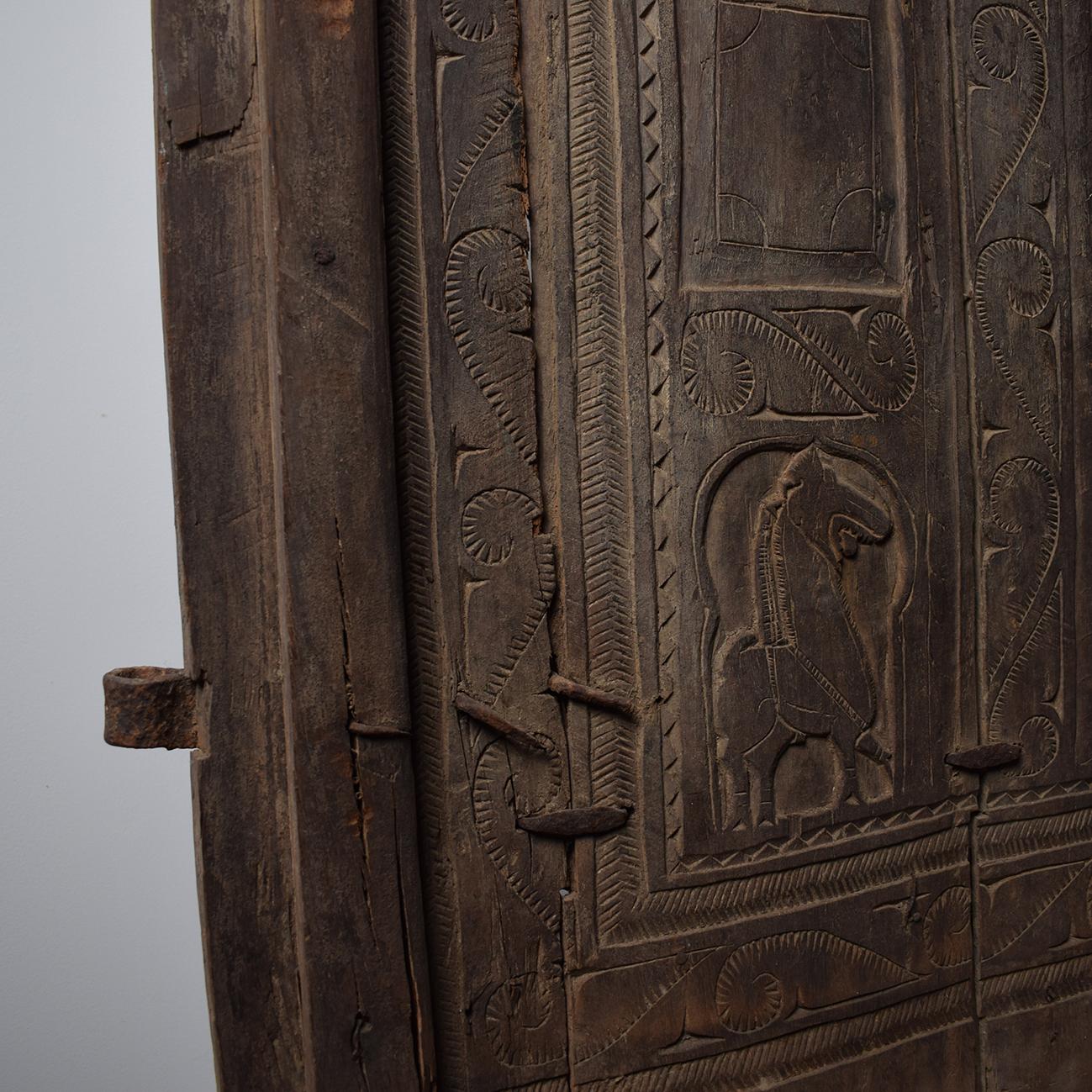 Originally situated at the entrance to a granary. 
Add a touch of magic to your interior with these beautiful early 20th century hand-carved door from India. A Unique work of art with a rich past. 
This door is very old with usage patina and