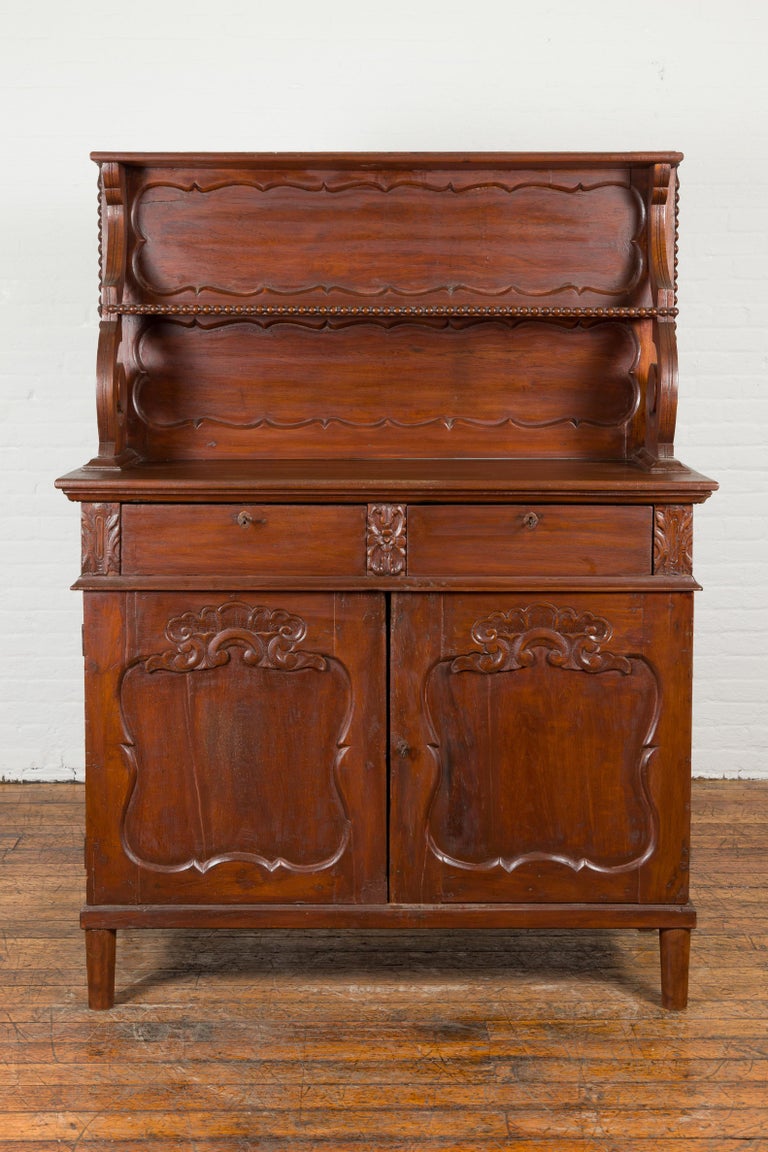 Carved Early 20th Century Indonesian Display Cabinet with Shelves, Drawers and Doors For Sale