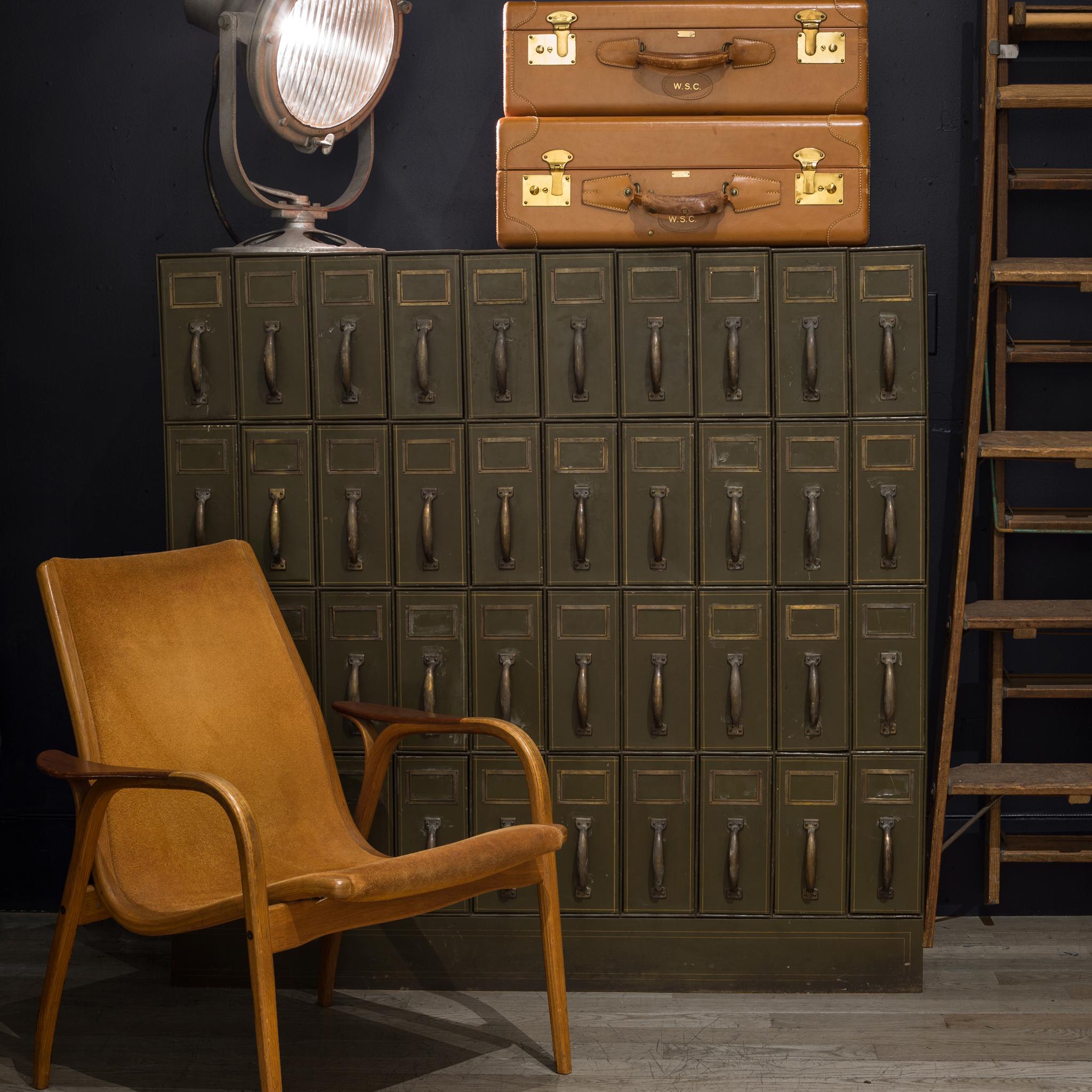 About

A large, Army green metal courthouse ledger file cabinet with 40 drawers and brass handles. Each drawer has a divider that slides smoothly along a track and a gold decorative line around them. This piece is very solidly built and has