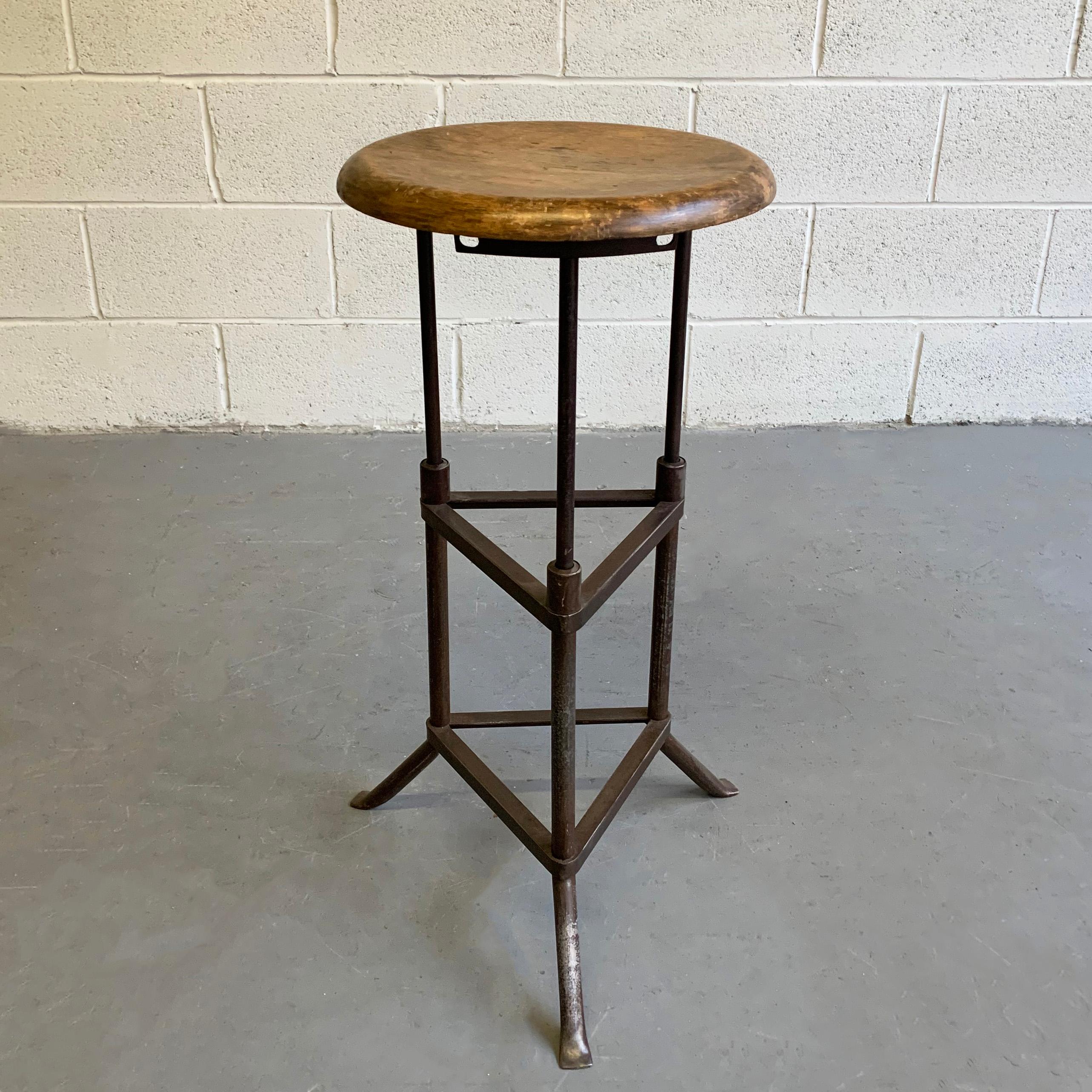 Industrial, early 20th century, drafting stool features s tripod, brushed steel base with 14 inch diameter, maple seat.