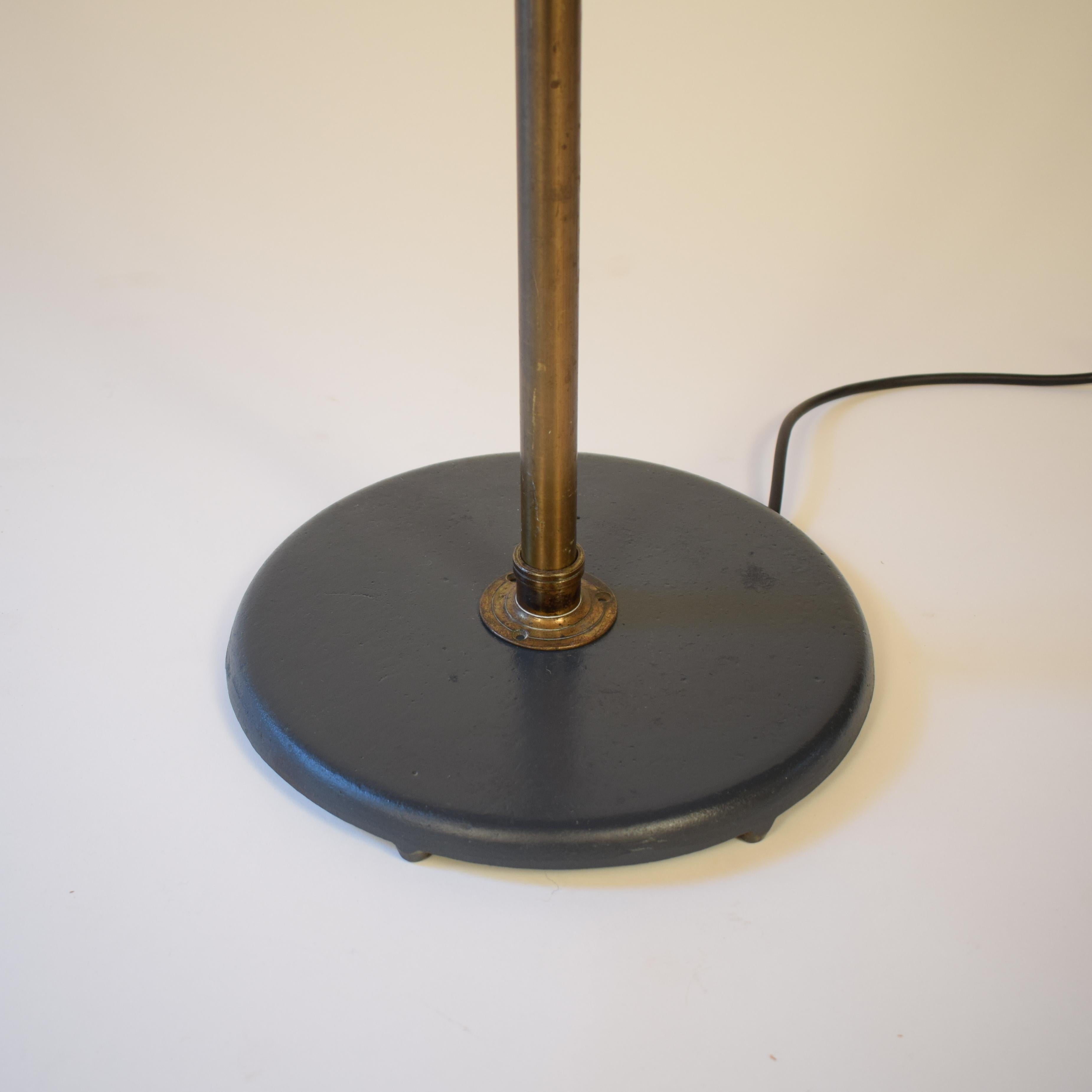 This beautiful industrial floor lamp is from the 1920s and was made in Germany.
The base and the top are made out of lacquered metal and the middle part is made out of brass.
It gives a nice and warm light.