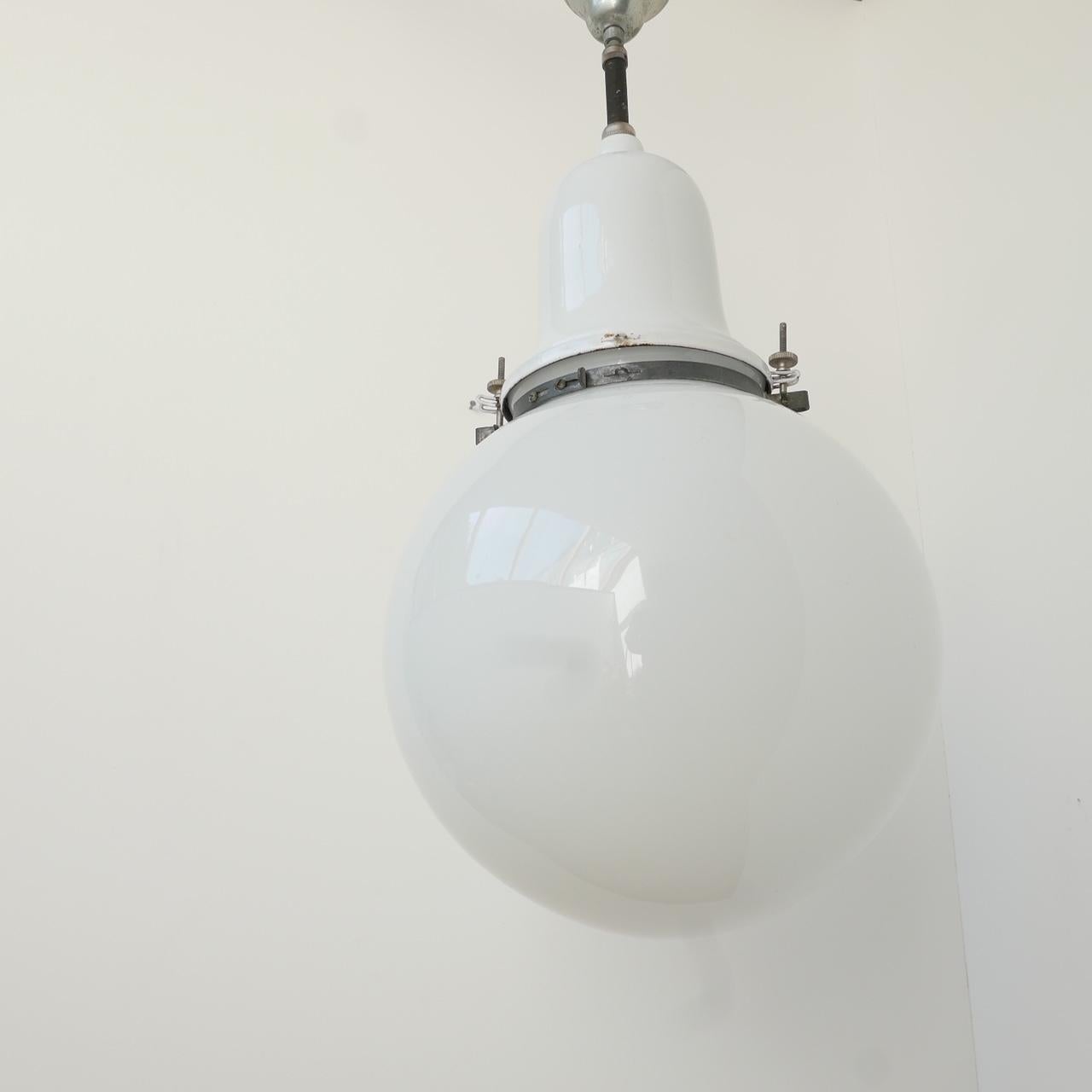 A large opaline globe pendant light, enamel and metal gallery. 

Swedish, early 20th century. 

Re-wired and PAT tested. 

Dimensions: approximately 72 total height x 35 diameter in cm.