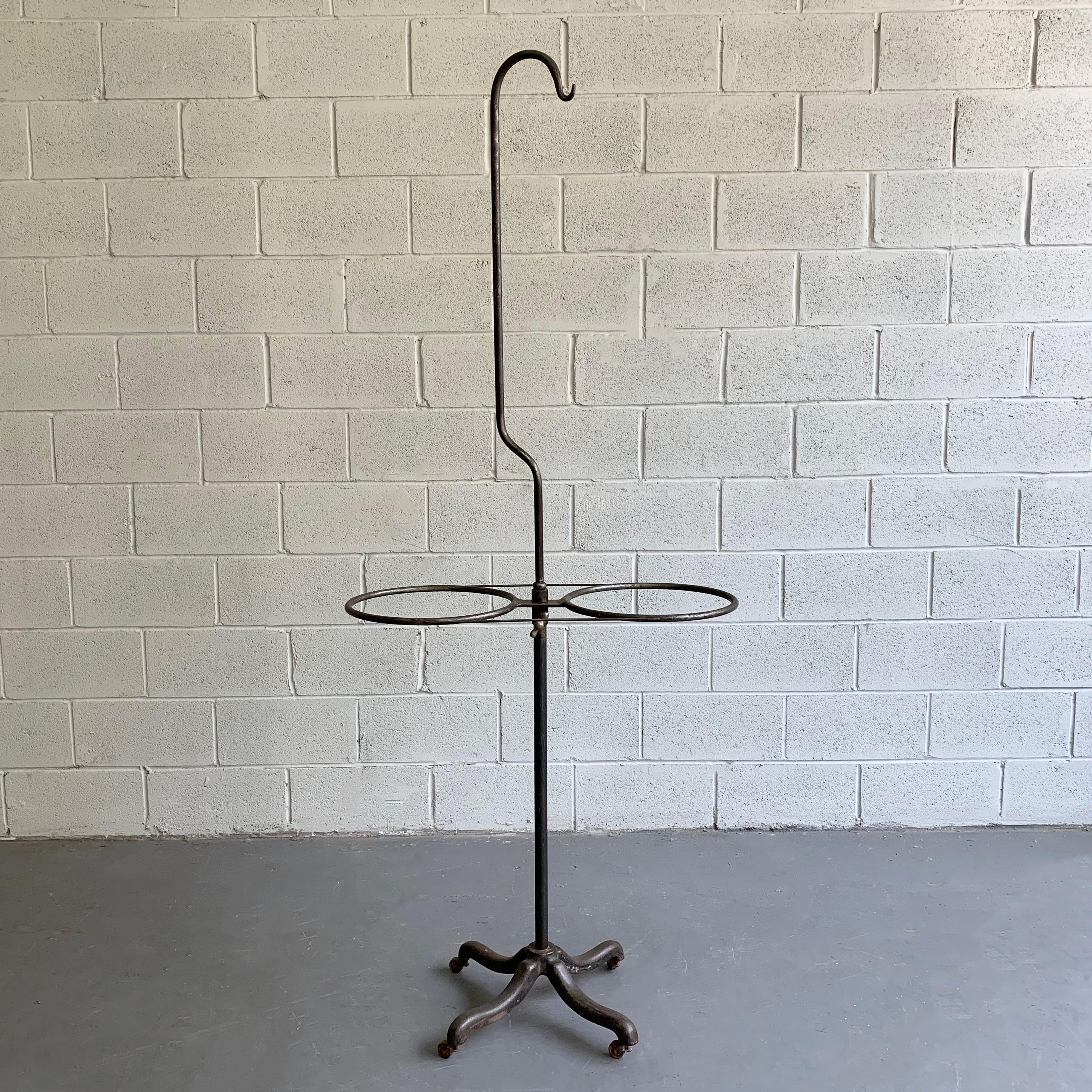Early 20th century, industrial, brushed steel, hospital, transfusion rolling rack features 2 tray holders at 34.5 inches height. This handsome, antique rack is very utilitarian and can be repurposed for multiple uses.