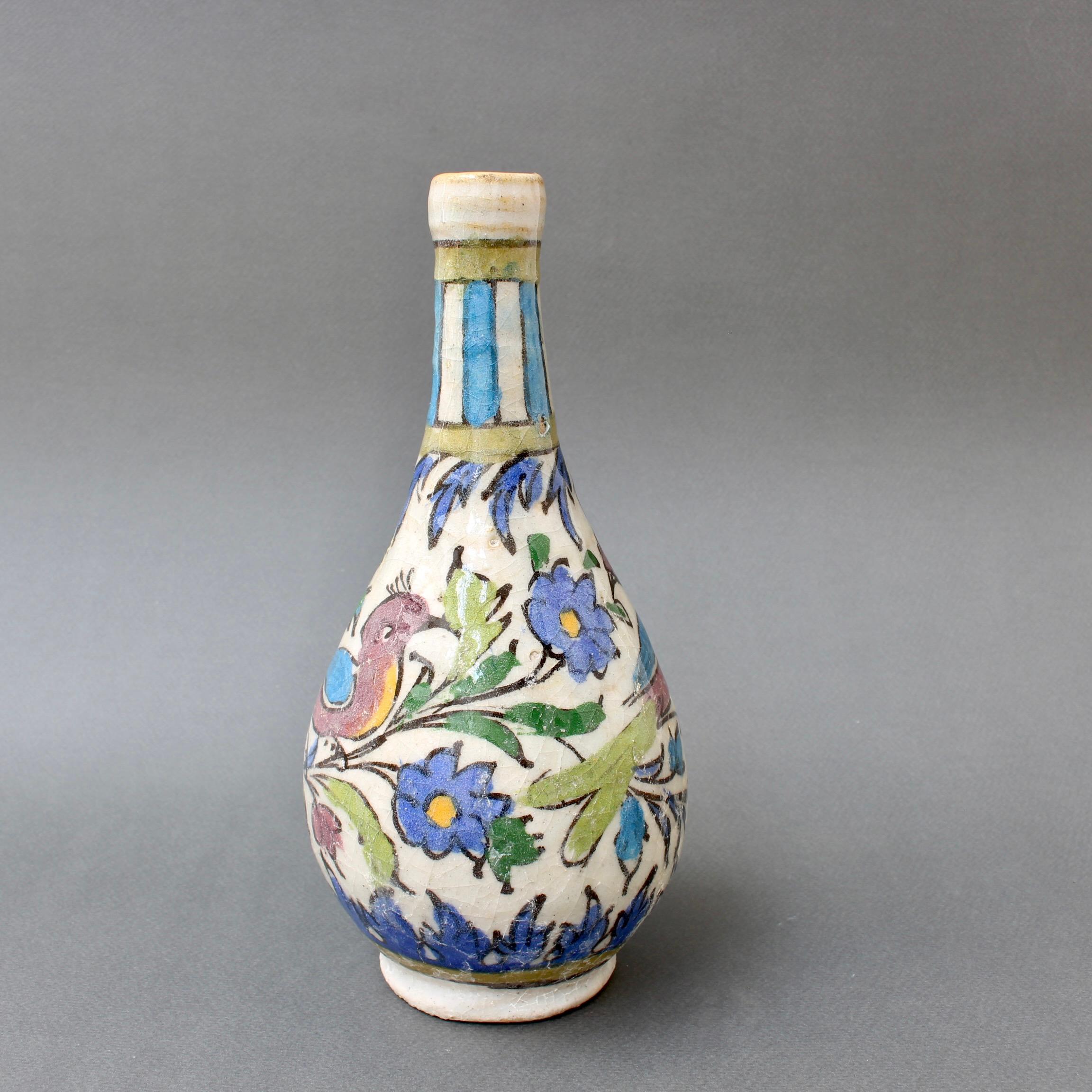 20th Century Persian ceramic flower vase. Discovered in the South of France, it was described by its previous owner as early 20th Century Iranian. It is glazed enamel with a bulbous body leading to a narrowed neck and opening in which several flower