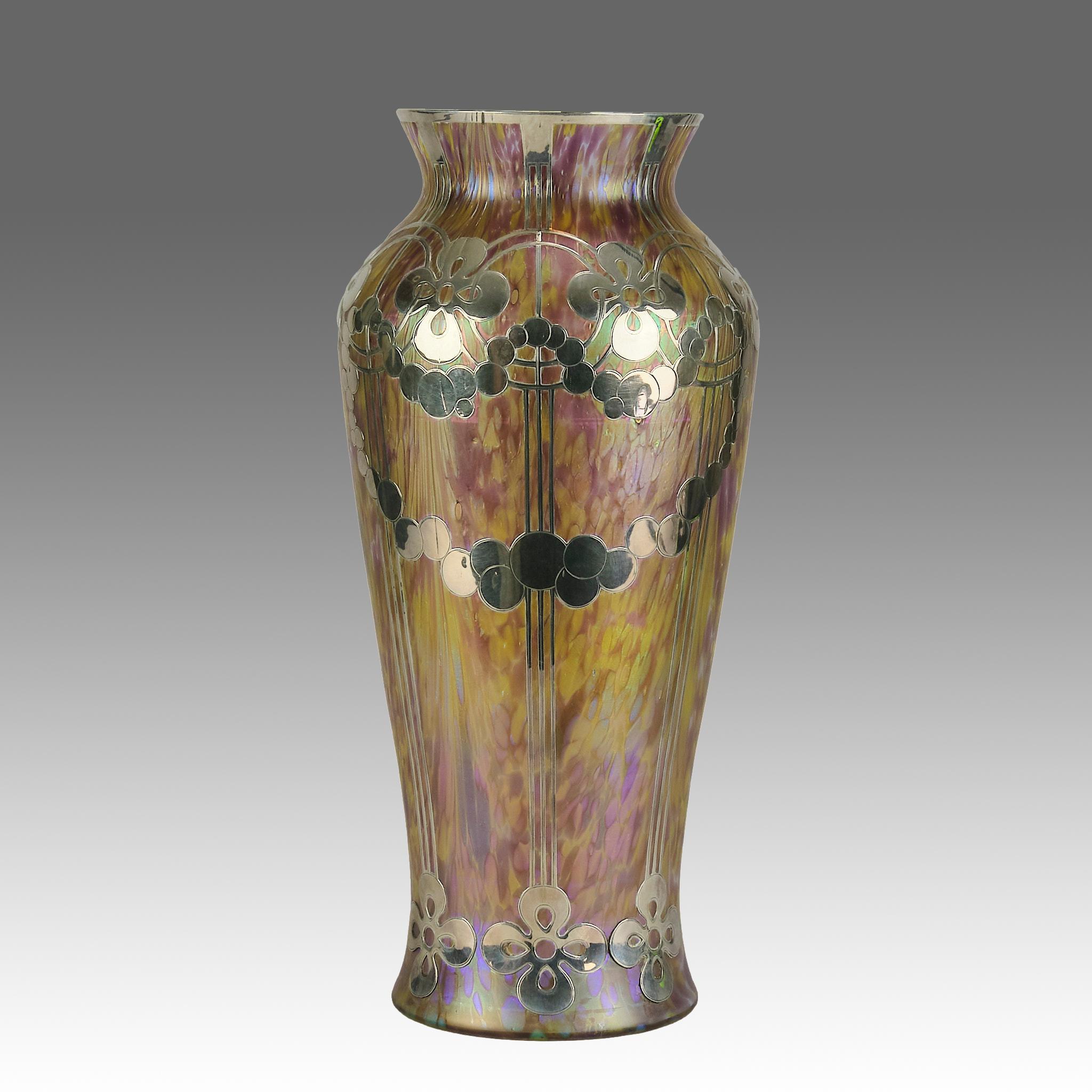 Magnificent early 20th Century secessionist glass vase cased with iridescent pink and golden colour with a beautiful geometric applied silver decoration in the Secessionist manner

ADDITIONAL INFORMATION
Height:                                     