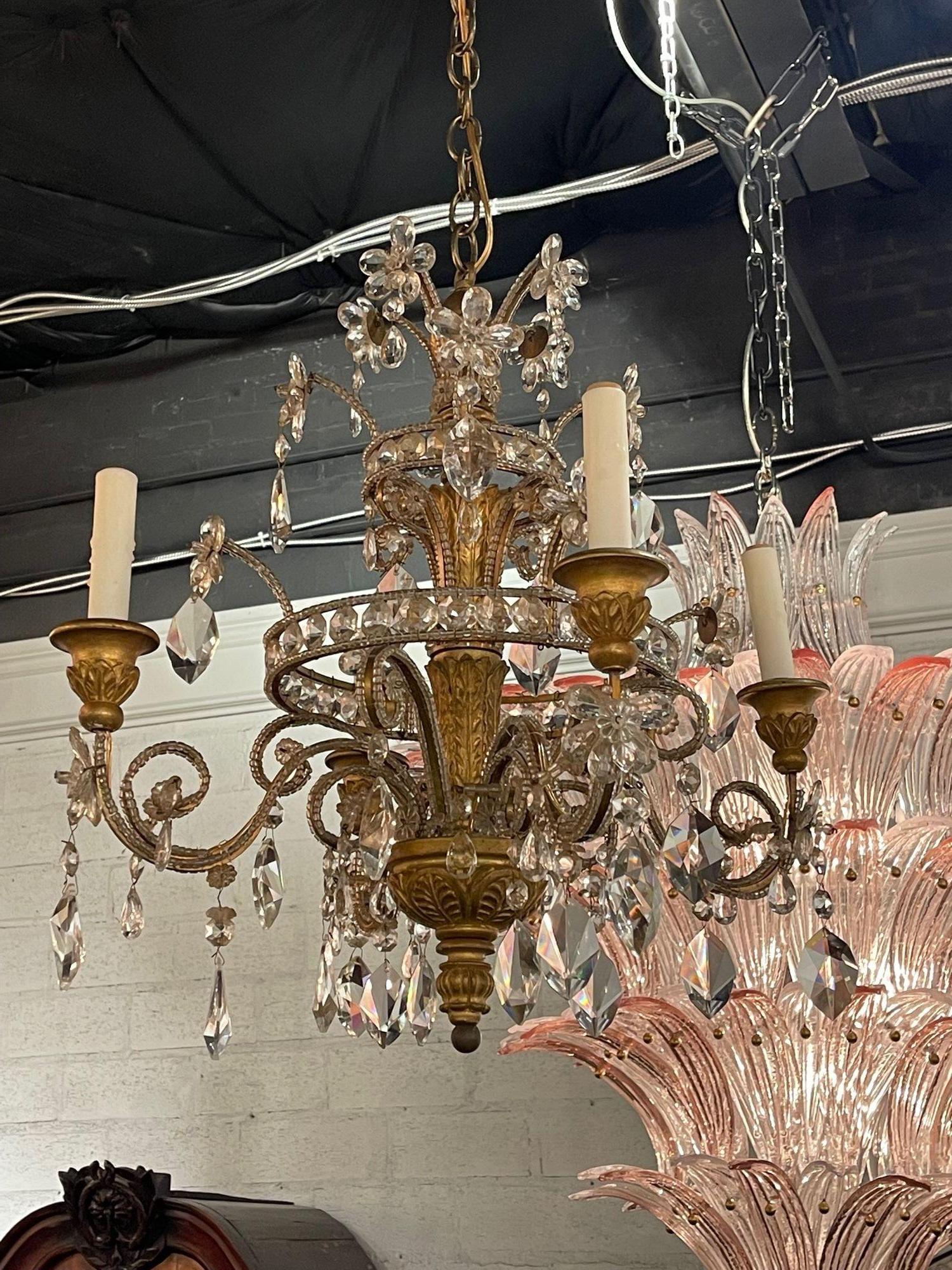 Early 20th century petite Italian giltwood and crystal 4-light chandelier. Circa 1920. The chandelier has been professionally re-wired, cleaned and is ready to hang. Includes matching chain and canopy.