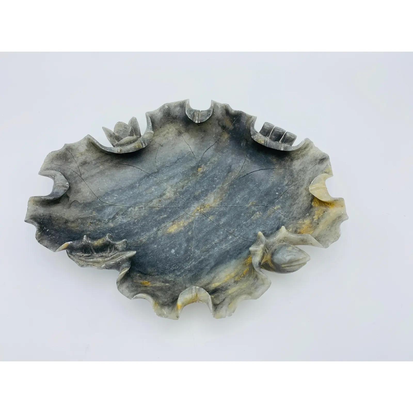 Listed is an absolutely stunning and rare, early 20th century, Italian dark alabaster sculptural lotus leaf dish. This hand carved piece has beautiful, natural veining all-over with heavily detailed edges of the 'leaf'. Incredibly gorgeous in