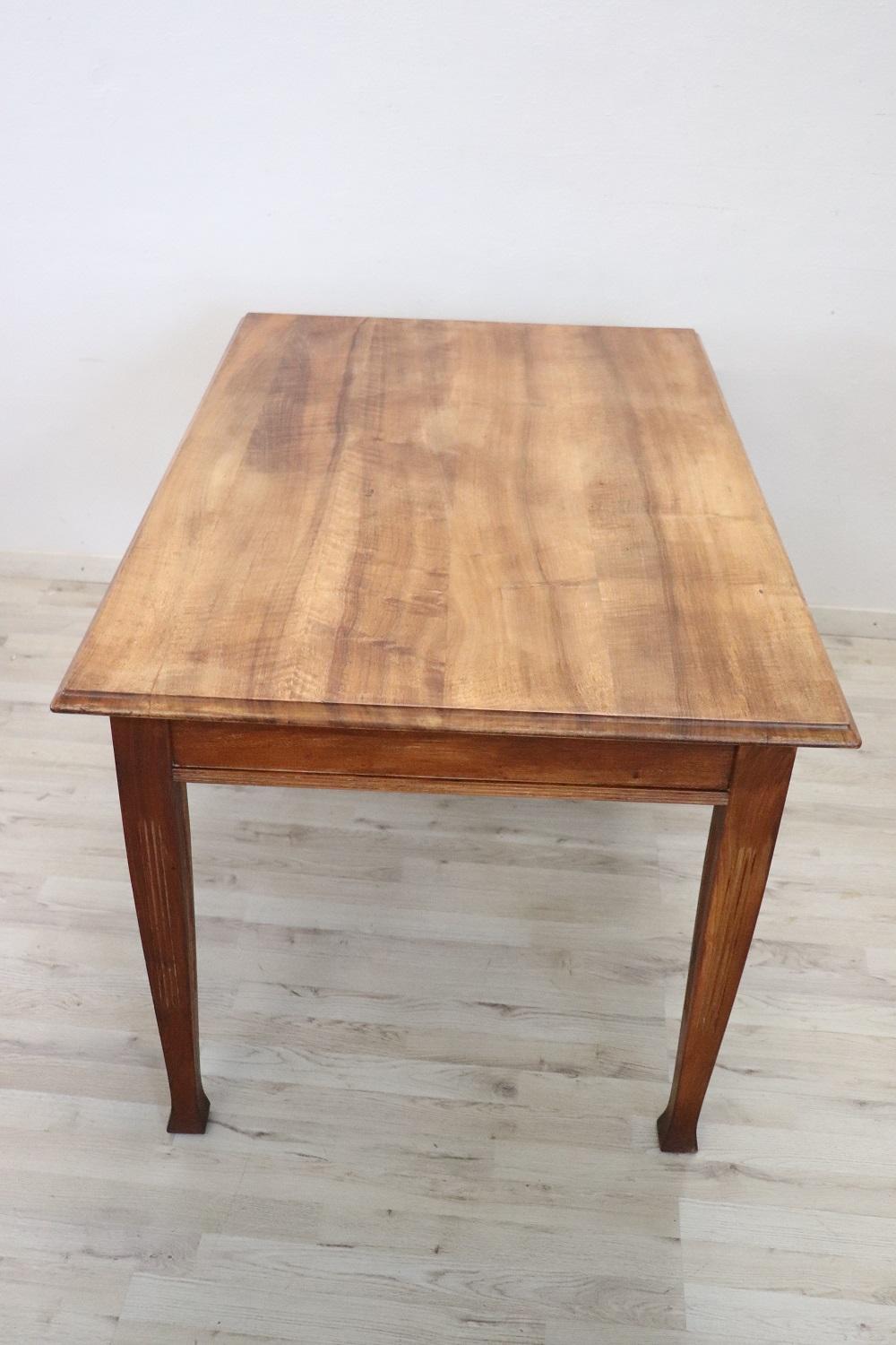 Beautiful Art Nouveau dining room table, 1920s in solid walnut wood. This table is perfect for a dining room. Very simple and linear, perfect to be inserted even in modern furnishings. Table in perfect conditions, you can immediately insert it in