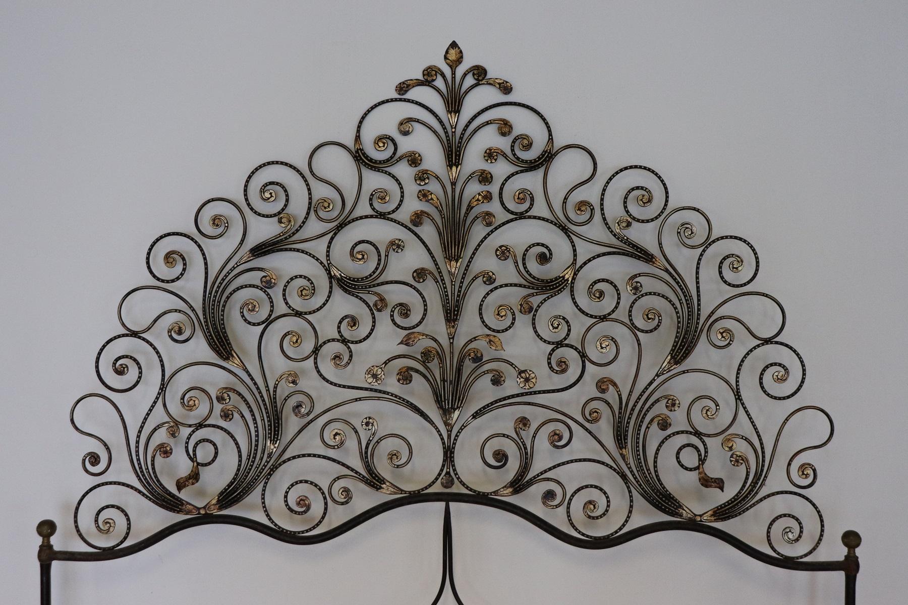 Italian Baroque style bed frame. Rich double bed headboard in gilded wrought iron. The iron has an ancient patina. Great woodwork with lots of curls and swirls of typical Italian Baroque taste. This type of beds in Italy were typical of the city of