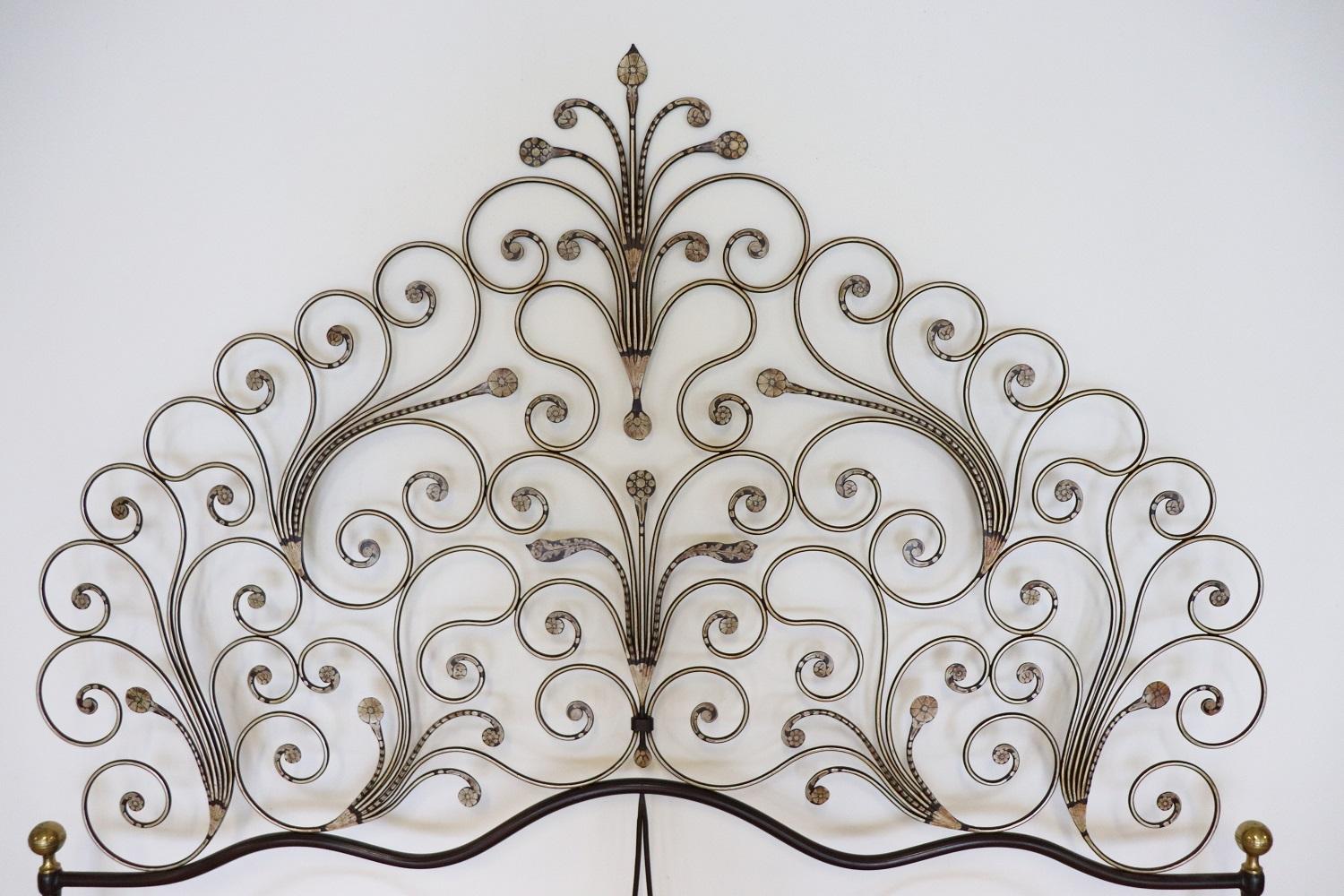Italian Baroque style bed frame. Rich double bed headboard in gilded wrought iron. The iron has an ancient patina. Great woodwork with lots of curls and swirls of typical Italian Baroque taste. This type of beds in Italy were typical of the city of