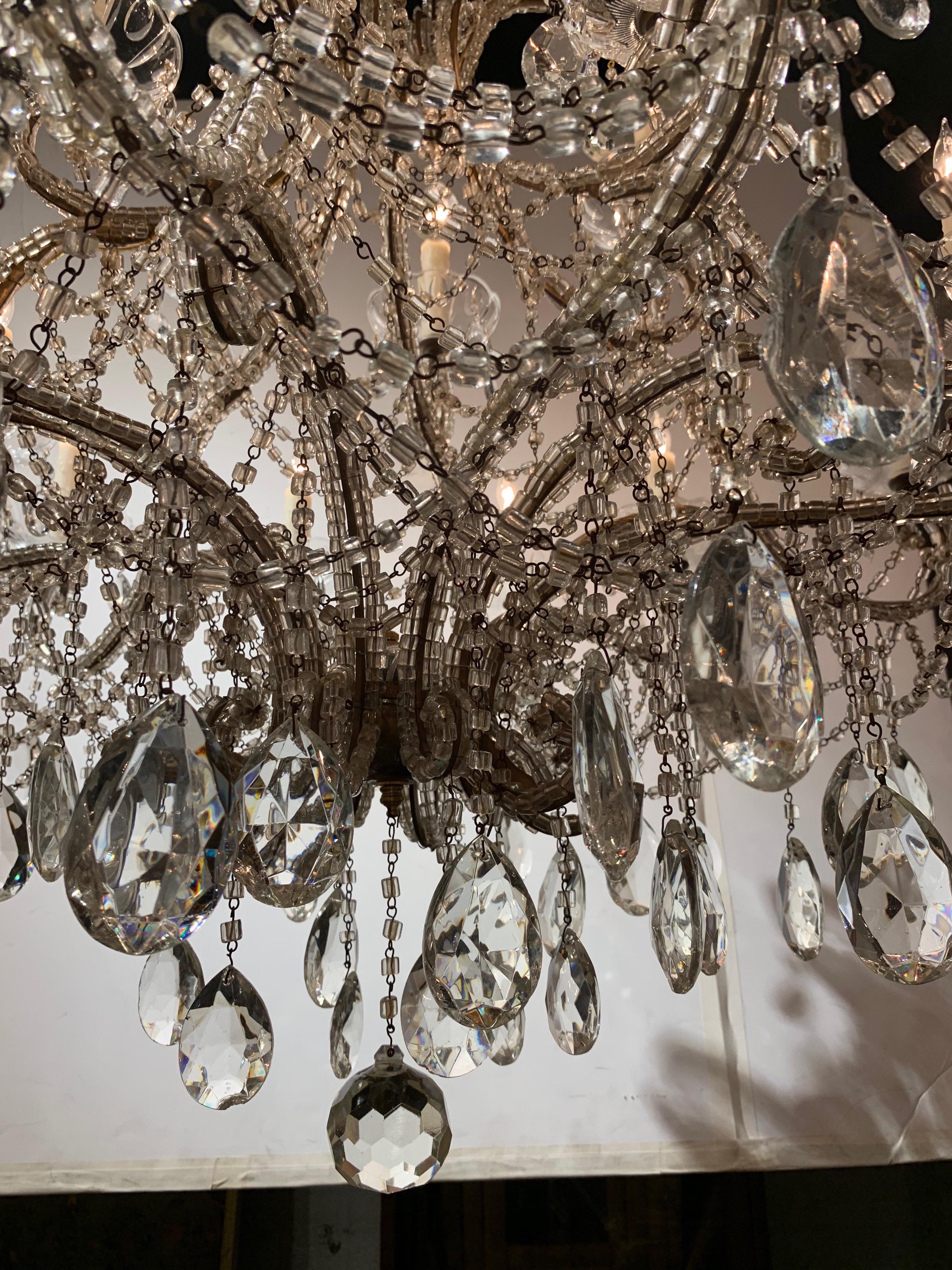 Italian beaded crystal 18-light chandelier. The chandelier’s frame is all hand beaded and there is a generous amount of dangling beads and prisms throughout the piece. A very elegant addition to a fine home.
 
 
