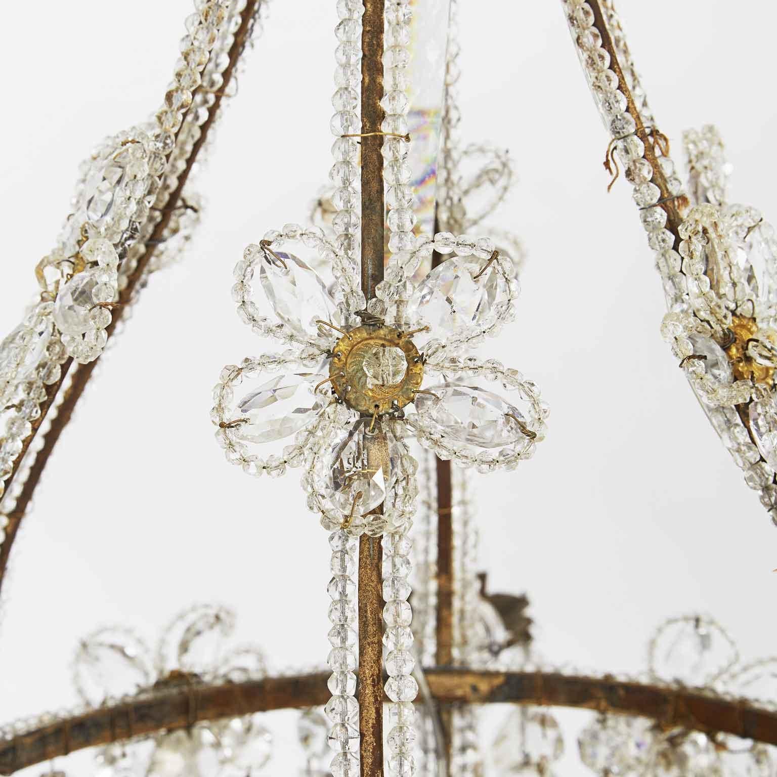 20th century Italian beaded crystal six-light chandelier, a lovely and romantic cage chandelier basket shape iron frame with gilded finish.
Six curved double beaded crystals arms ending with original flower shaped gilded iron bobeiges.

The iron