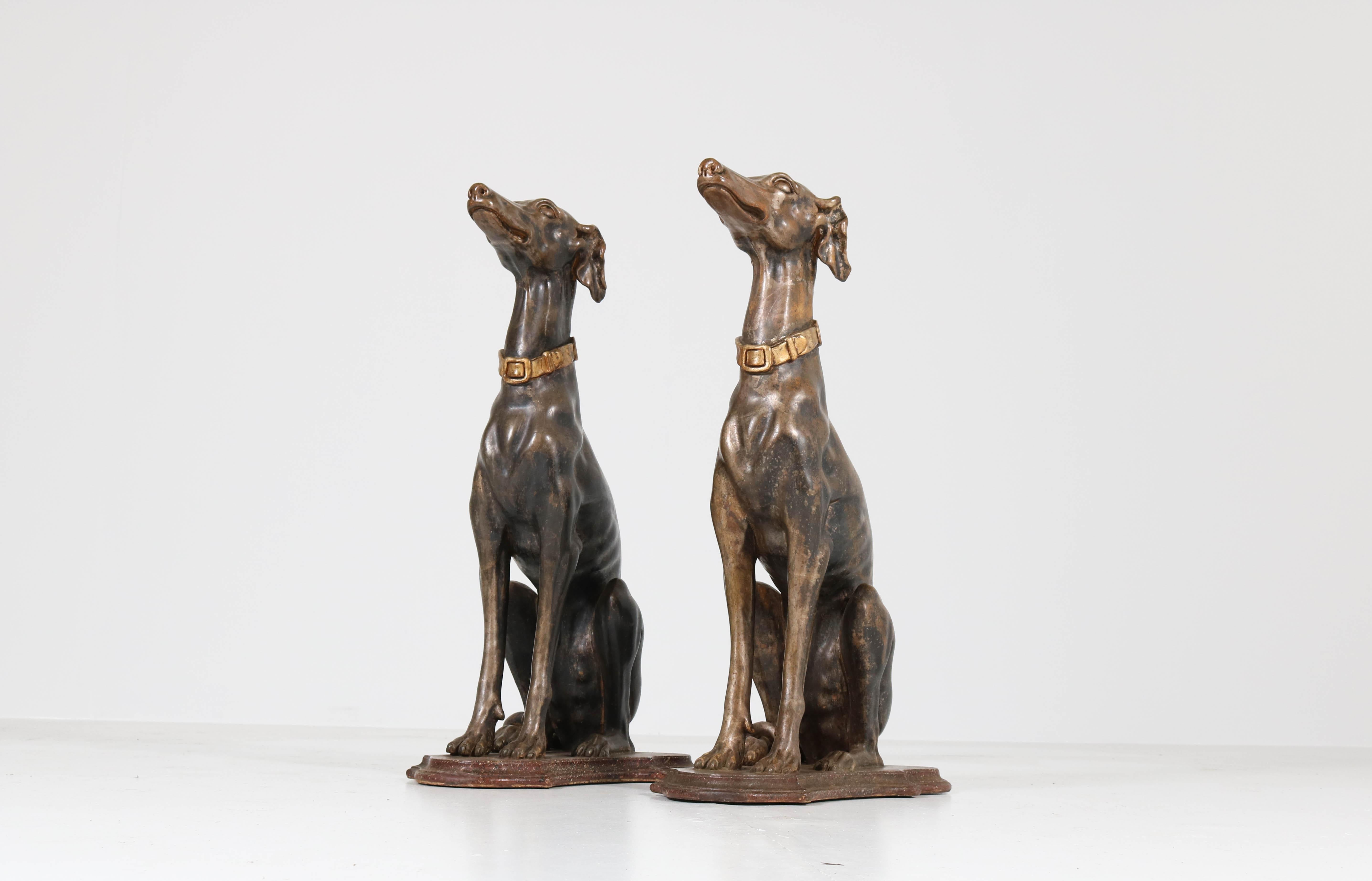 Stunning and elegant pair of early 20th century greyhound sculptures.
The lean and muscular dogs are sitting quietly on the original faux-marble
painted bases.
Lacquered in grey with wonderful details such as their heads, ears and bodies as well