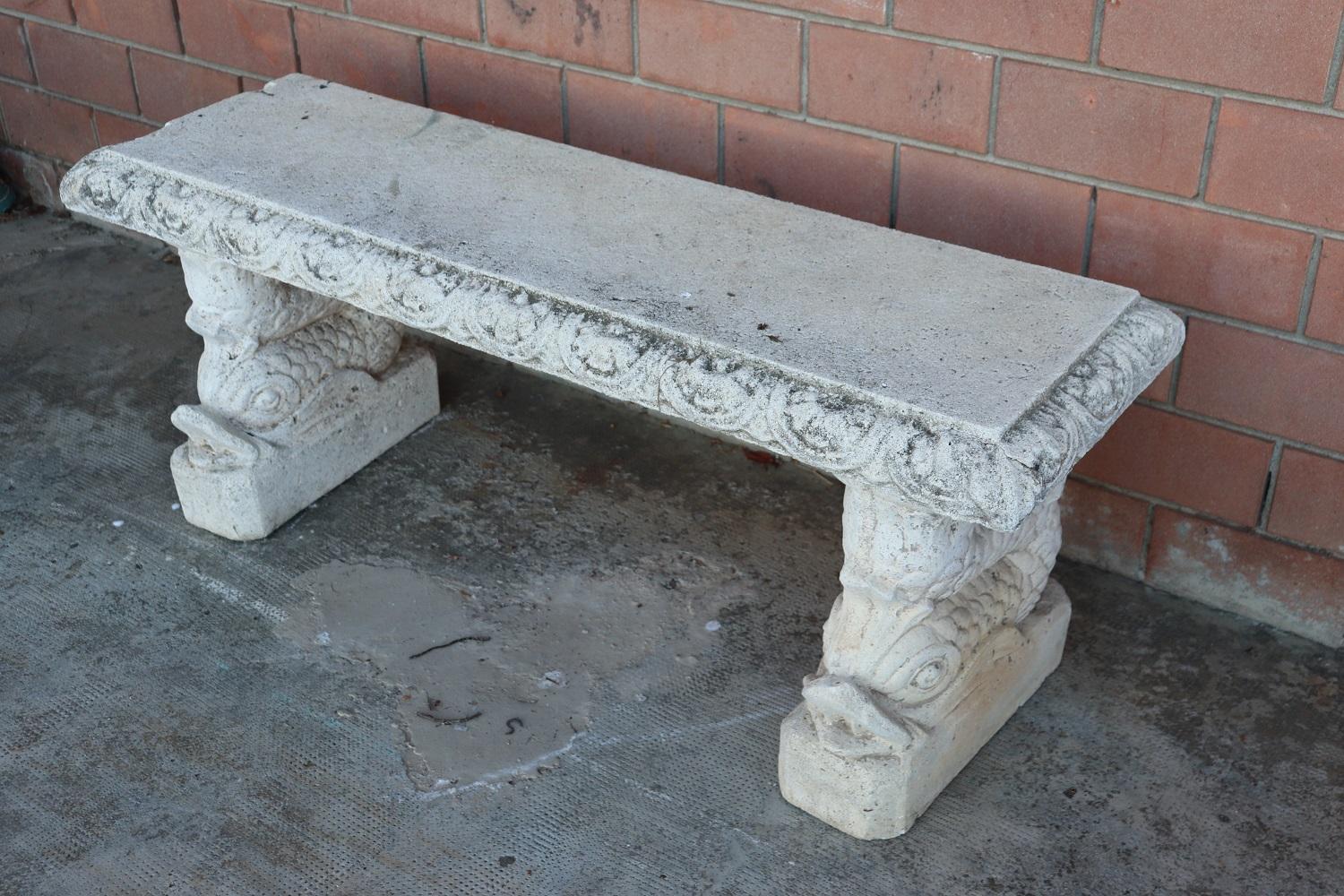 Beautiful refined garden ad outdoor bench. Beautiful and majestic in mixed material of concrete and stone. The bench has a refined classic decoration with large tritons supporting the seat of the bench. The bench shows signs of the passage of time.