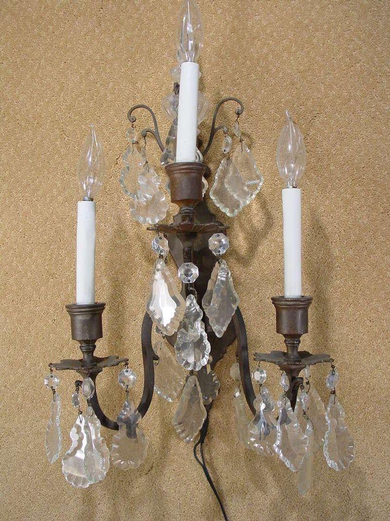 Pair of Italian bronze and crystal wall sconces featuring beautifully cut crystal beads and accents. Each sconce was three lights.

Please inquire us if you would like a different quantity, up to three are available upon request.