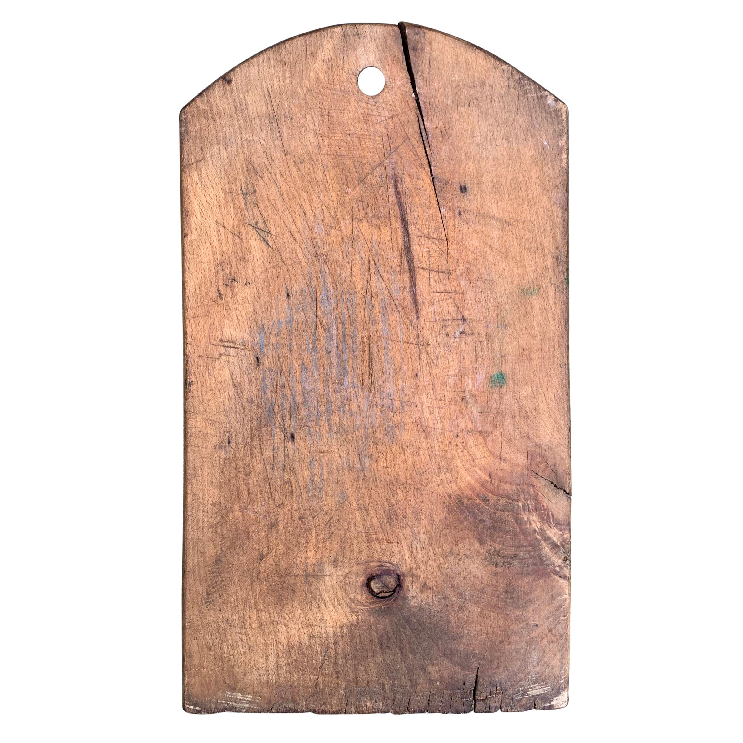 A wonderfully worn early 20th century Italian cutting board with a beautiful patina. All that’s missing is a selection of cheeses, charcuterie, and your guests.