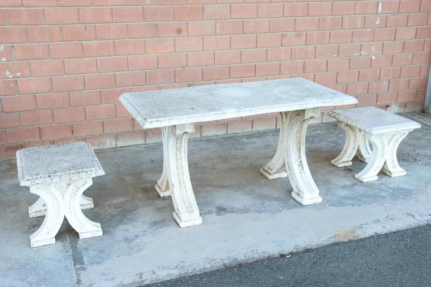 Beautiful refined garden set, circa 1920s main material stone mixed with gravel and cement. Beautiful rectangular table with two stools. The stone shows signs of the passage of time, two defects of wear on the table top, see photo details. This