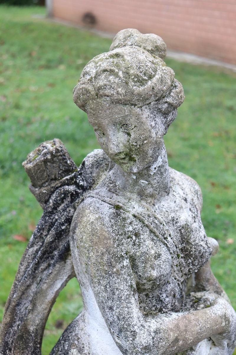 Beautiful refined garden statue, circa 1920s main material stone mixed with cement and marble dust, stone grit. Beautiful and majestic statue. A beautiful representation of Diana the goddess of hunting with a bow and arrows and her faithful dog at