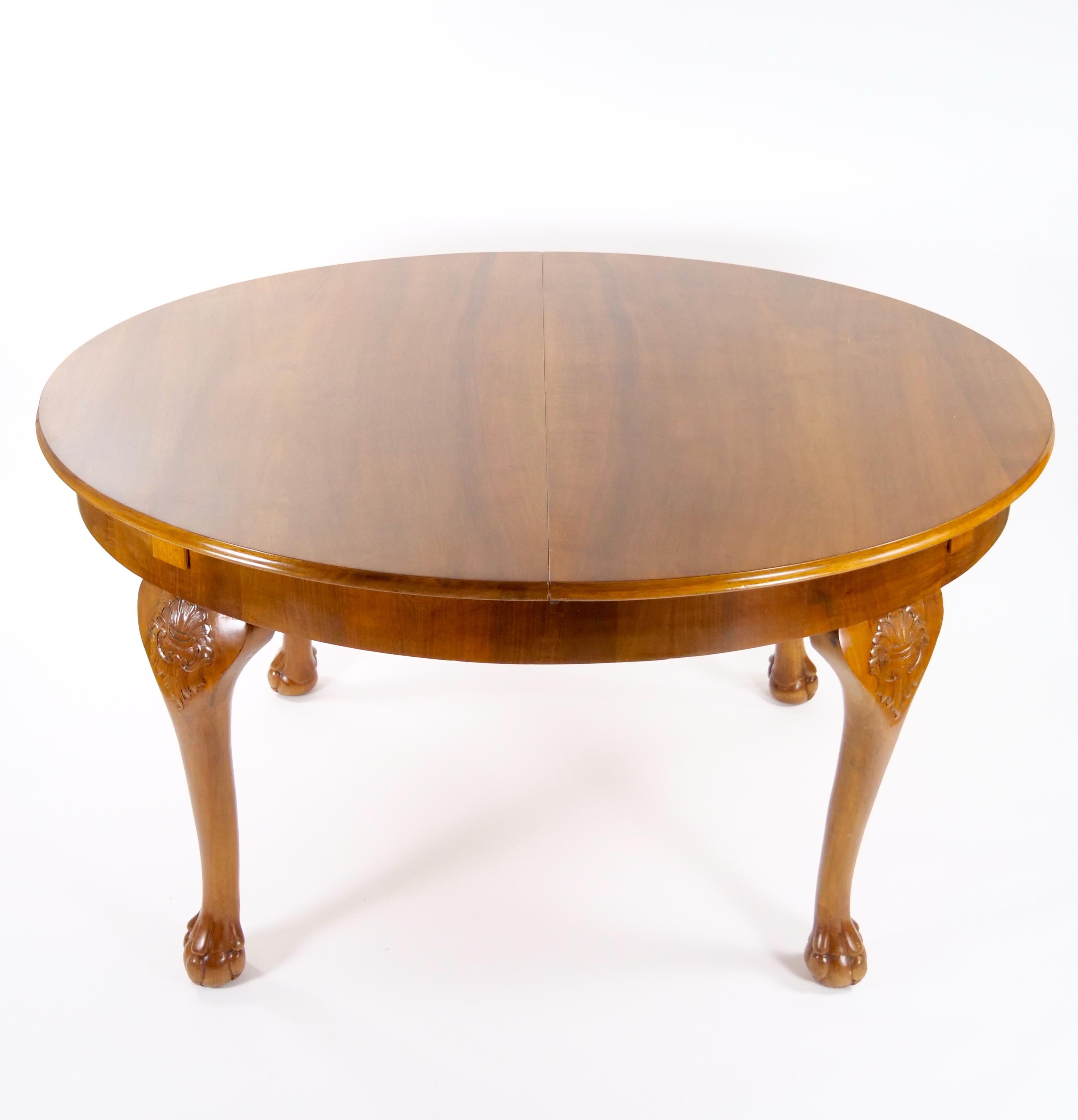 Transform your dining room with this exquisite Early 20th Century Italian Hand-Carved Walnut Neoclassical Style Dining Table. This oval-shaped dining table is a true masterpiece, meticulously crafted from rich walnut wood and adorned with intricate