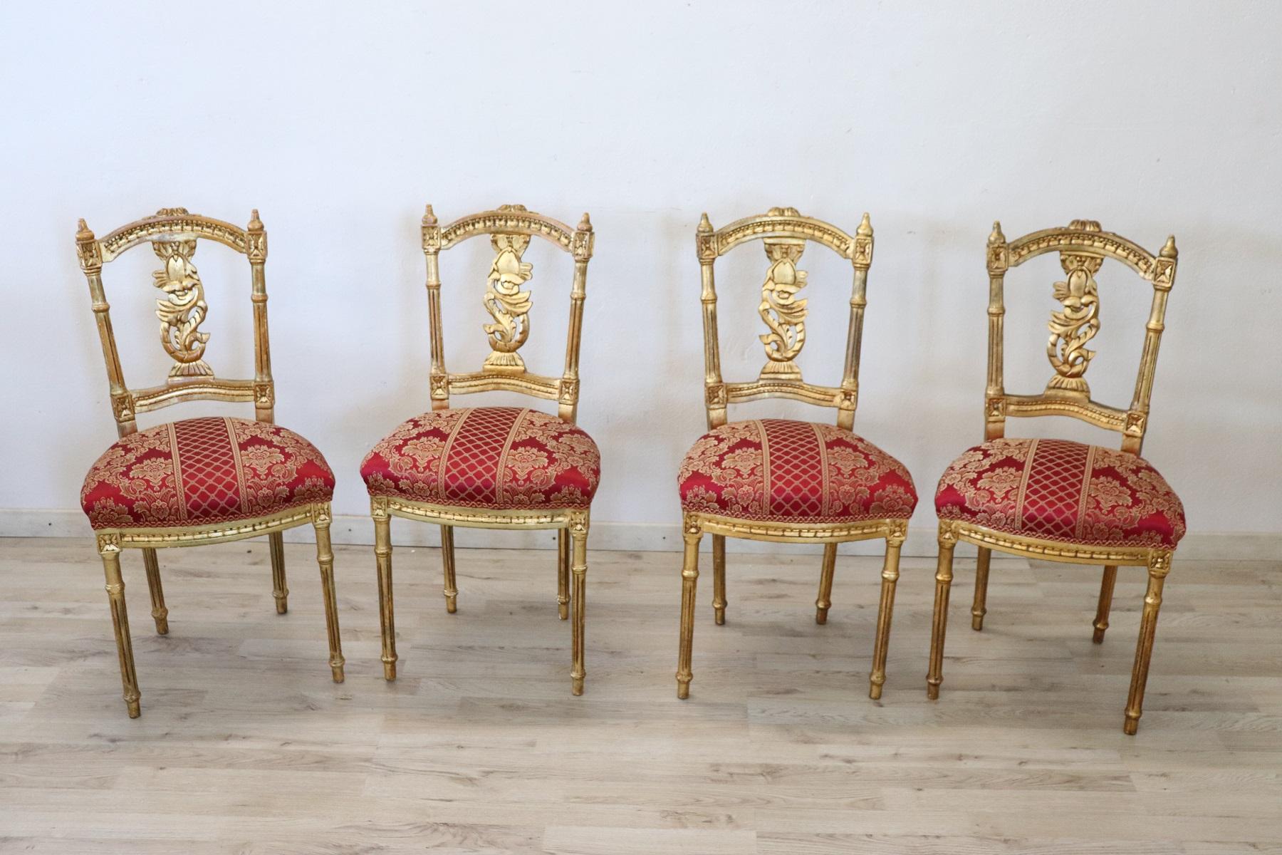Series of four refined early 20th century authentic Italian louis XVI style chairs. These chairs are of extreme refinement made of carved wood with decorated back and completely covered in precious gold leaf. The session has been restored. The