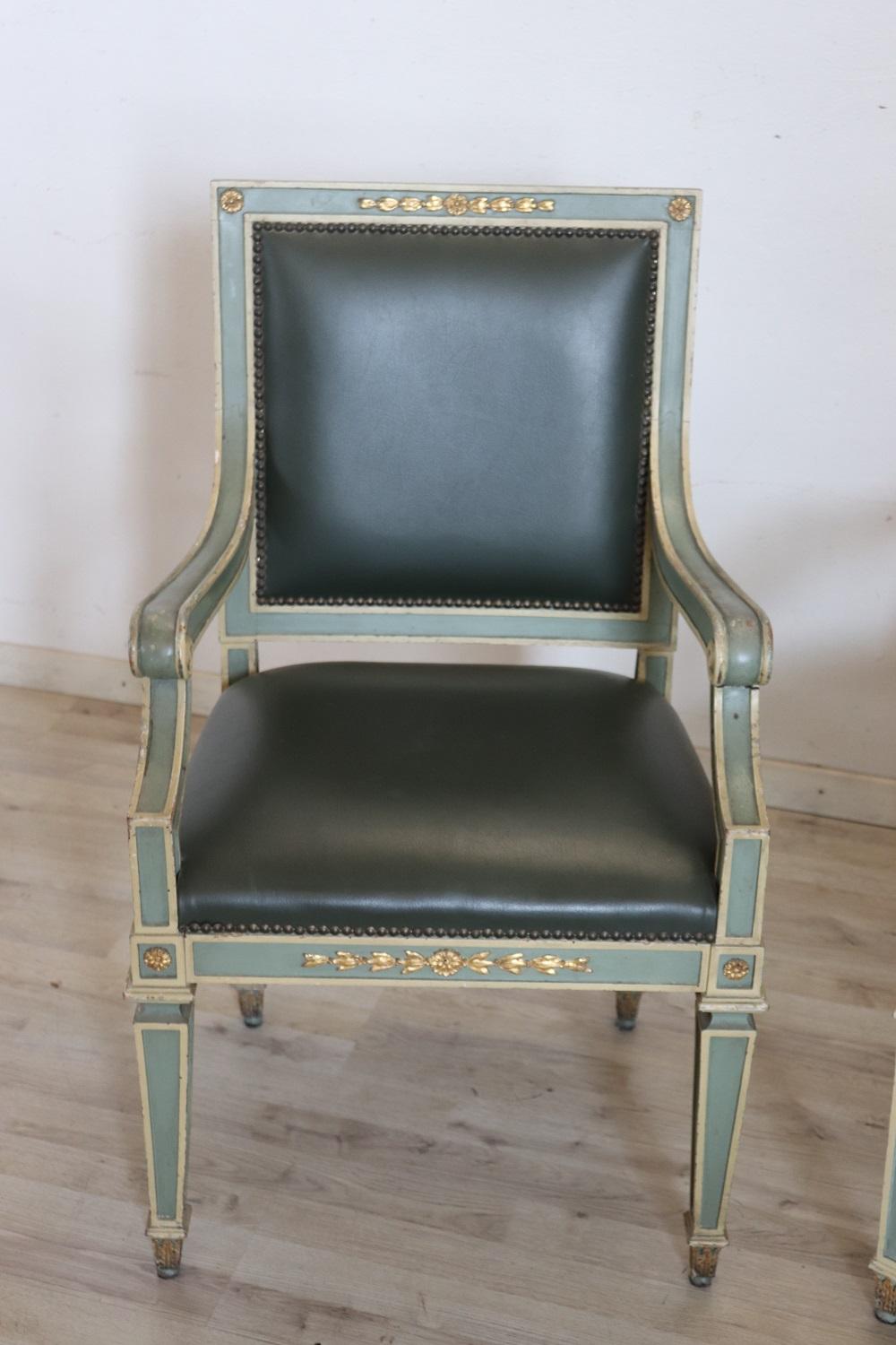 Lovely Italian antique armchairs, set of 2, 1930s. These armchairs are Louis XVI style in lacquered wood with fine gilt decorations. Upholstered in green imitation leather. This beautiful armchair has an enveloping shape and a comfortable seat. Used