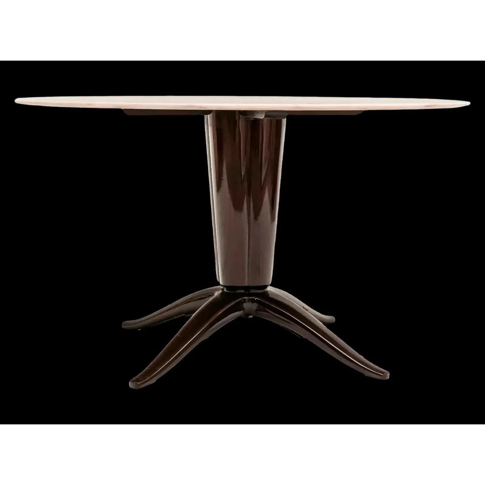 Borsani Style French Art Deco round dining table. Mahogany finish with four legs supporting a tapered column supporting a light pink-beige marble top. Beautiful piece.