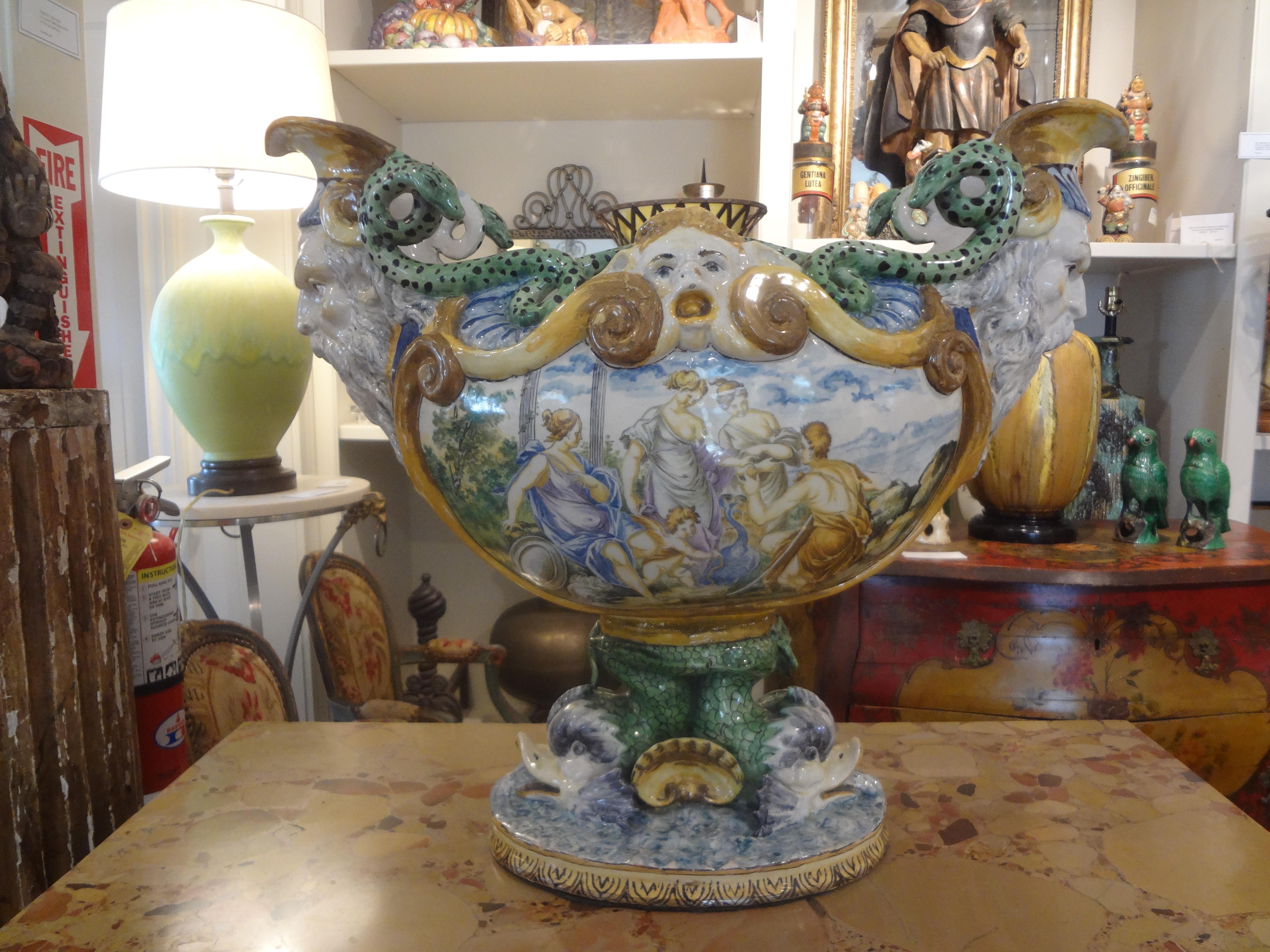 Early 20th century Italian majolica urn. This gorgeous Italian majolica or maiolica urn or jardiniere is hand decorated with serpents, dolphins and shells. Large enough to accommodate your favorite orchid plant, fresh flowers, blooming plant or
