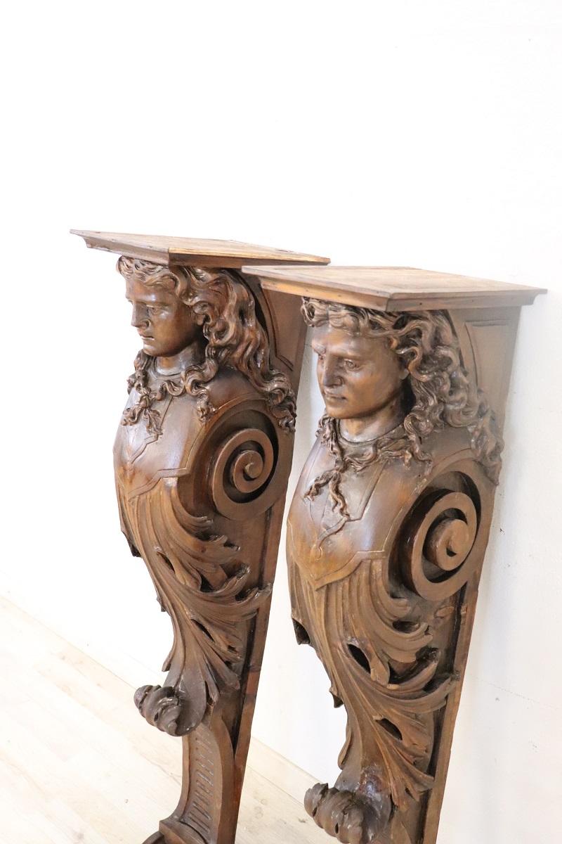 Spectacular pair of pilasters in walnut wood. Characterized by refined wood carving work with two large charitids. High artistic quality. Perfect as a decorative element.