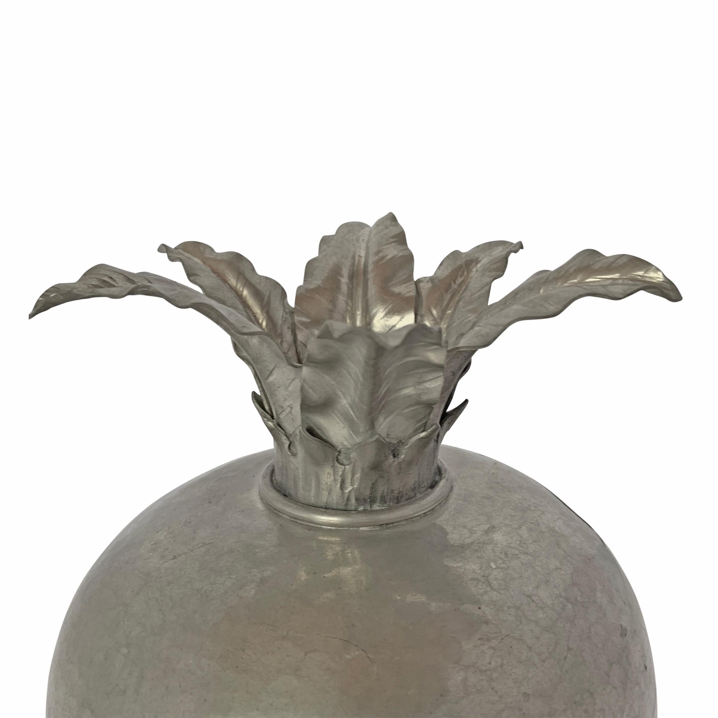 An early 20th century Italian hand-hammered pewter pomegranate-form vase with six large leaves and wonderful texture. Marked, 