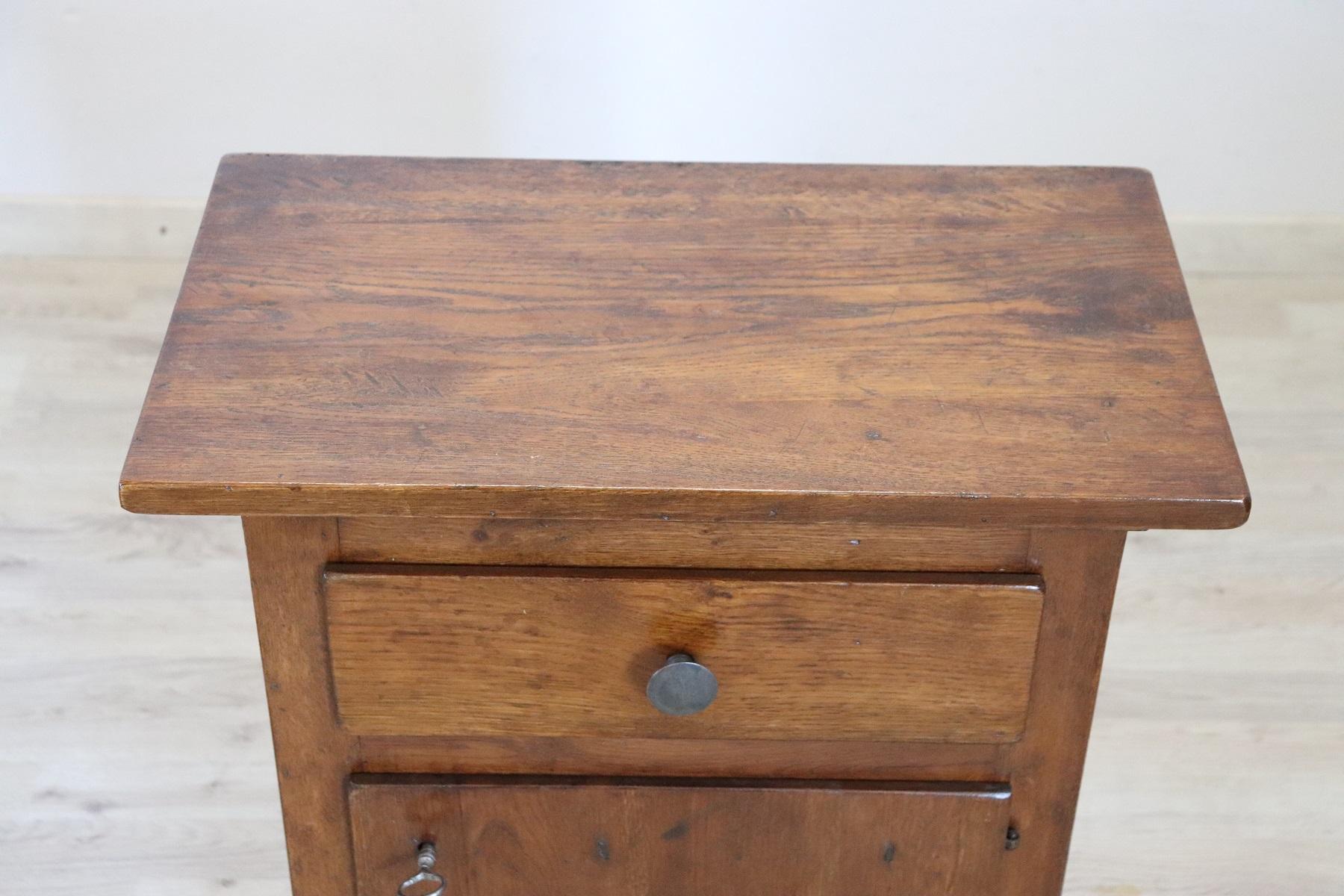 Italian rustic nightstand 1910s in solid oak wood. The nightstand very refined linear and elegant. On the front one-drawer and one-door Very elegant ideal in every room of the house. Restored, ready to be inserted in your beautiful home.